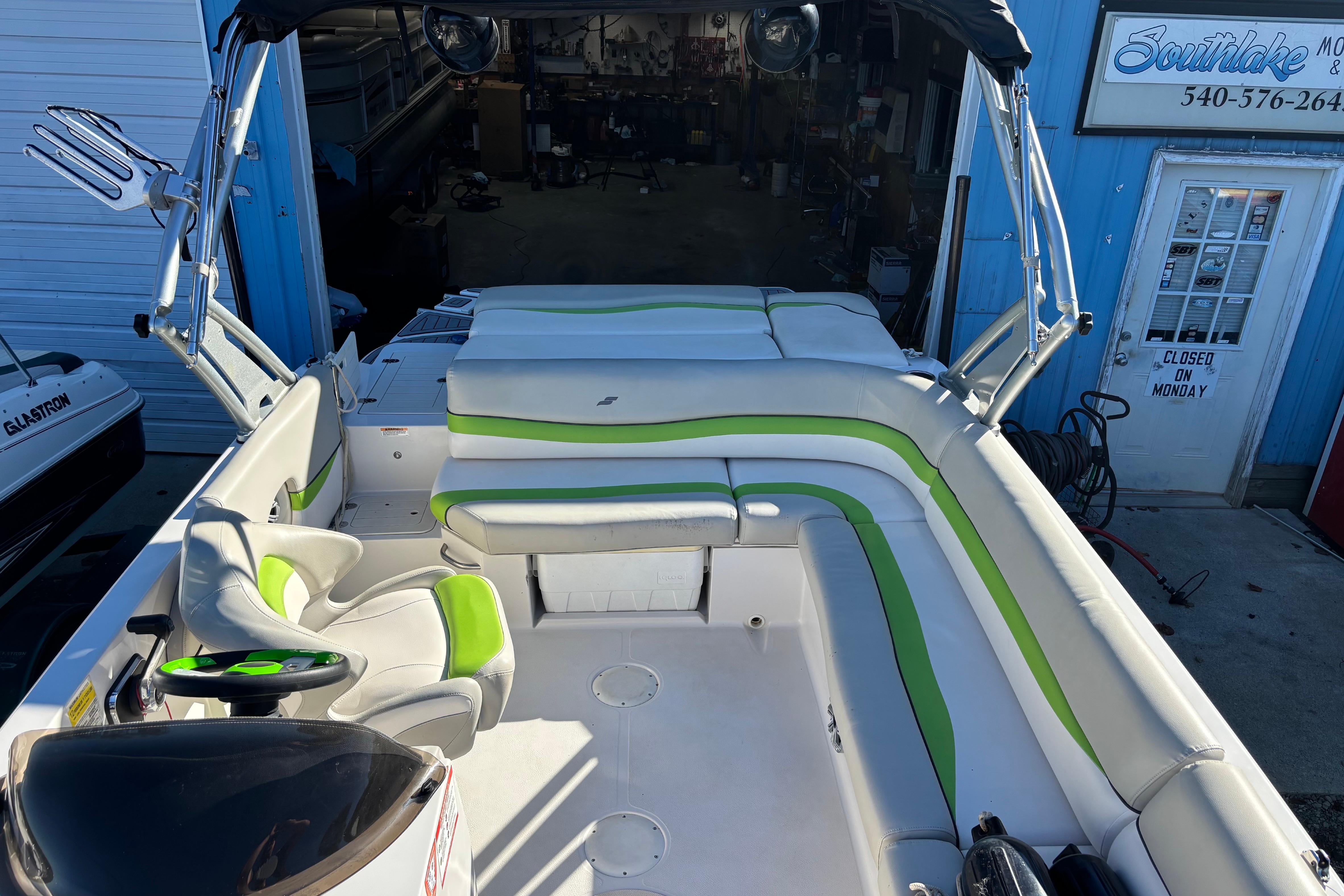2018 Starcraft Star Step 221 I/O boat interior with green and white seating.