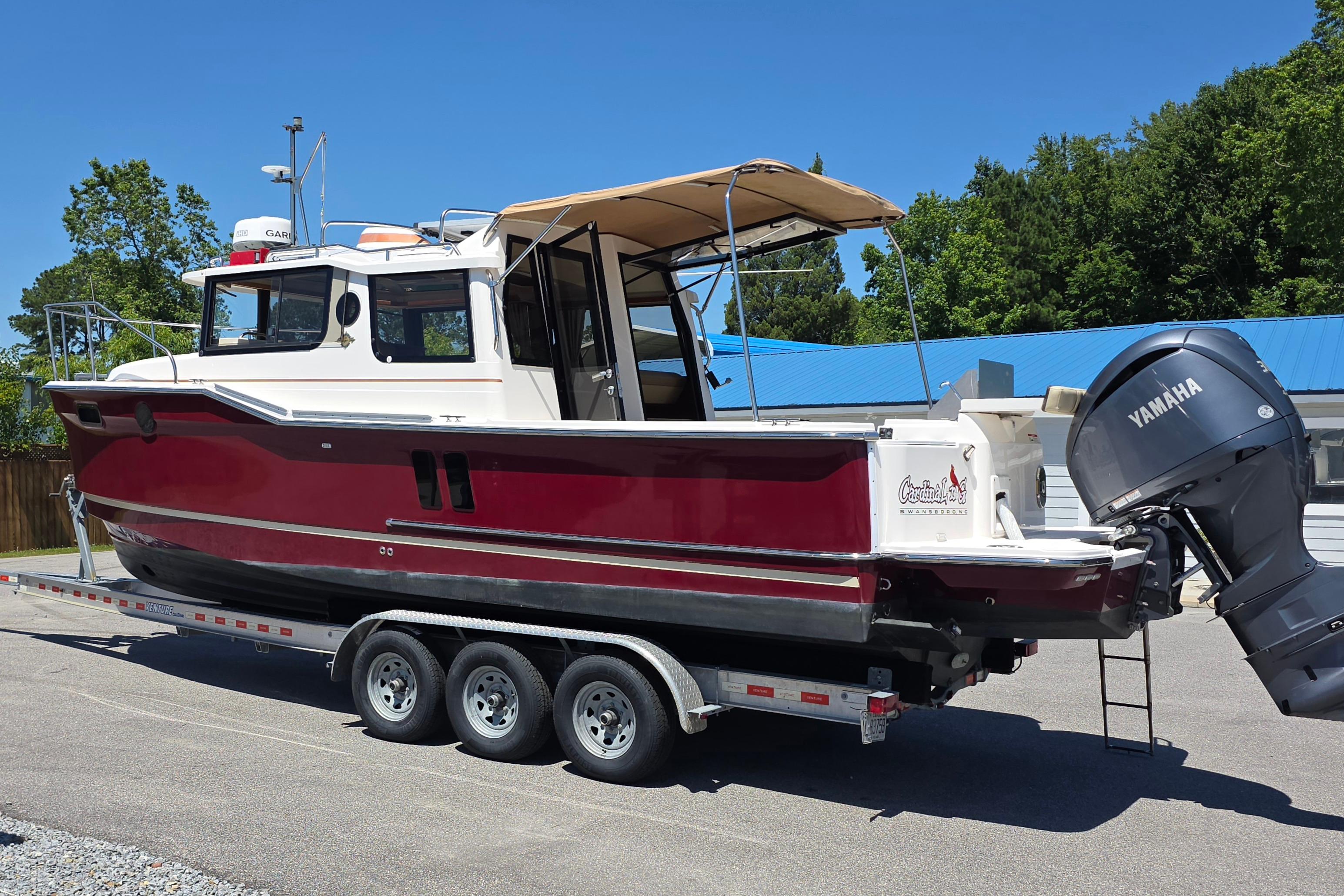 2021 Ranger Tug R27 boat on trailer with Yamaha outboard motor.