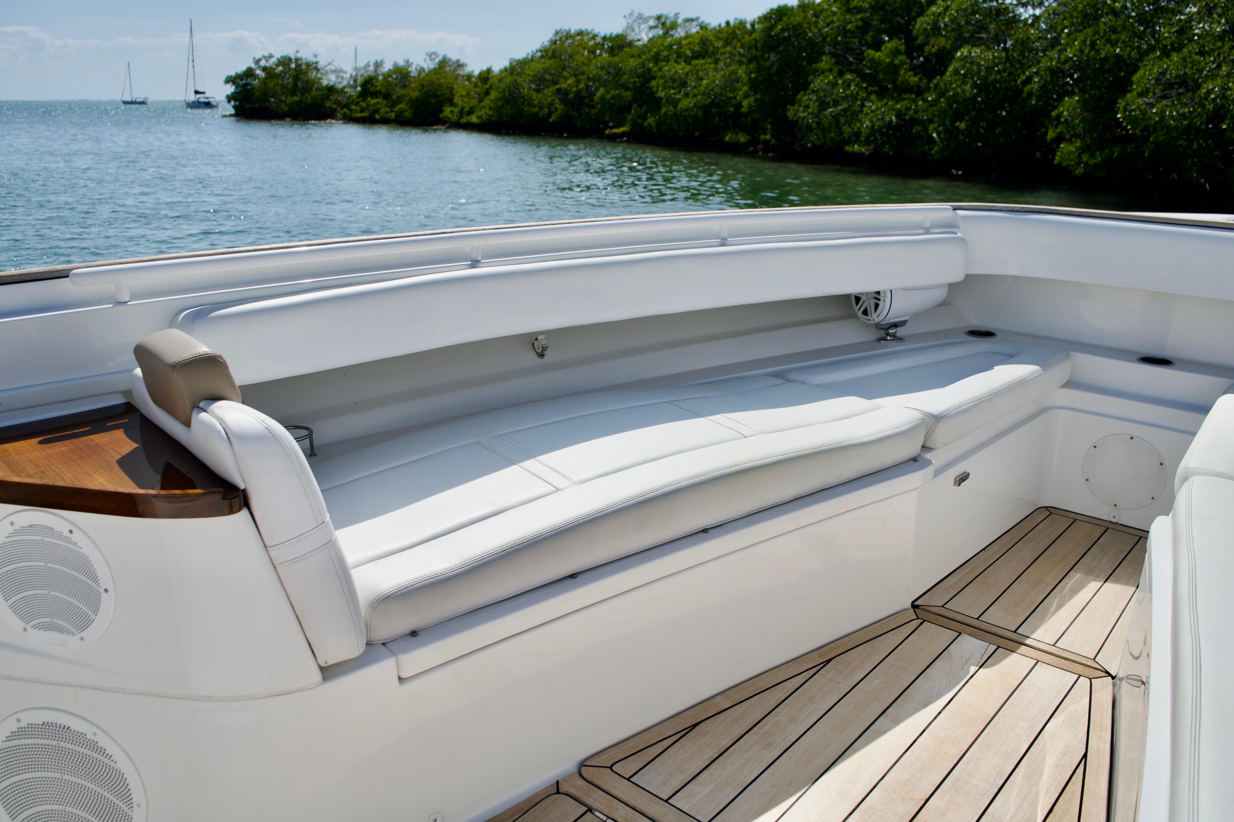 Luxurious seating area on 2019 HCB 53 Suenos boat with scenic water view.