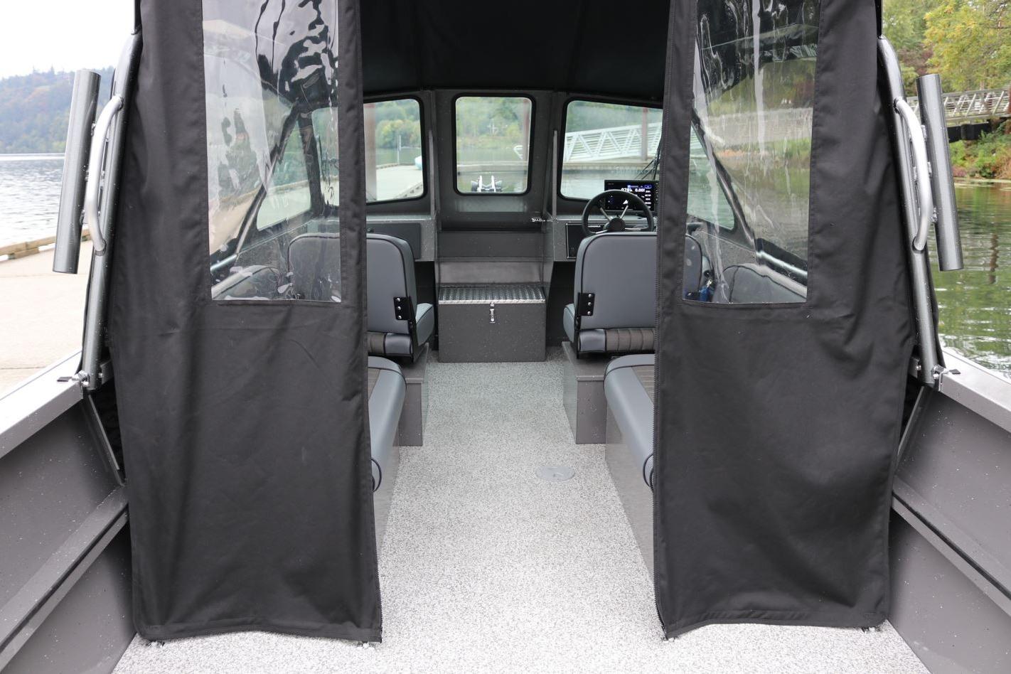 Interior view of 2026 Alumaweld Intruder 22 boat with seating and steering console.