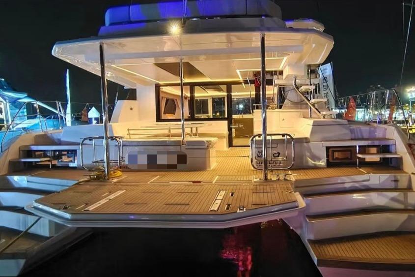 Luxurious 2022 Leopard 50 yacht at night, featuring spacious deck and modern design.