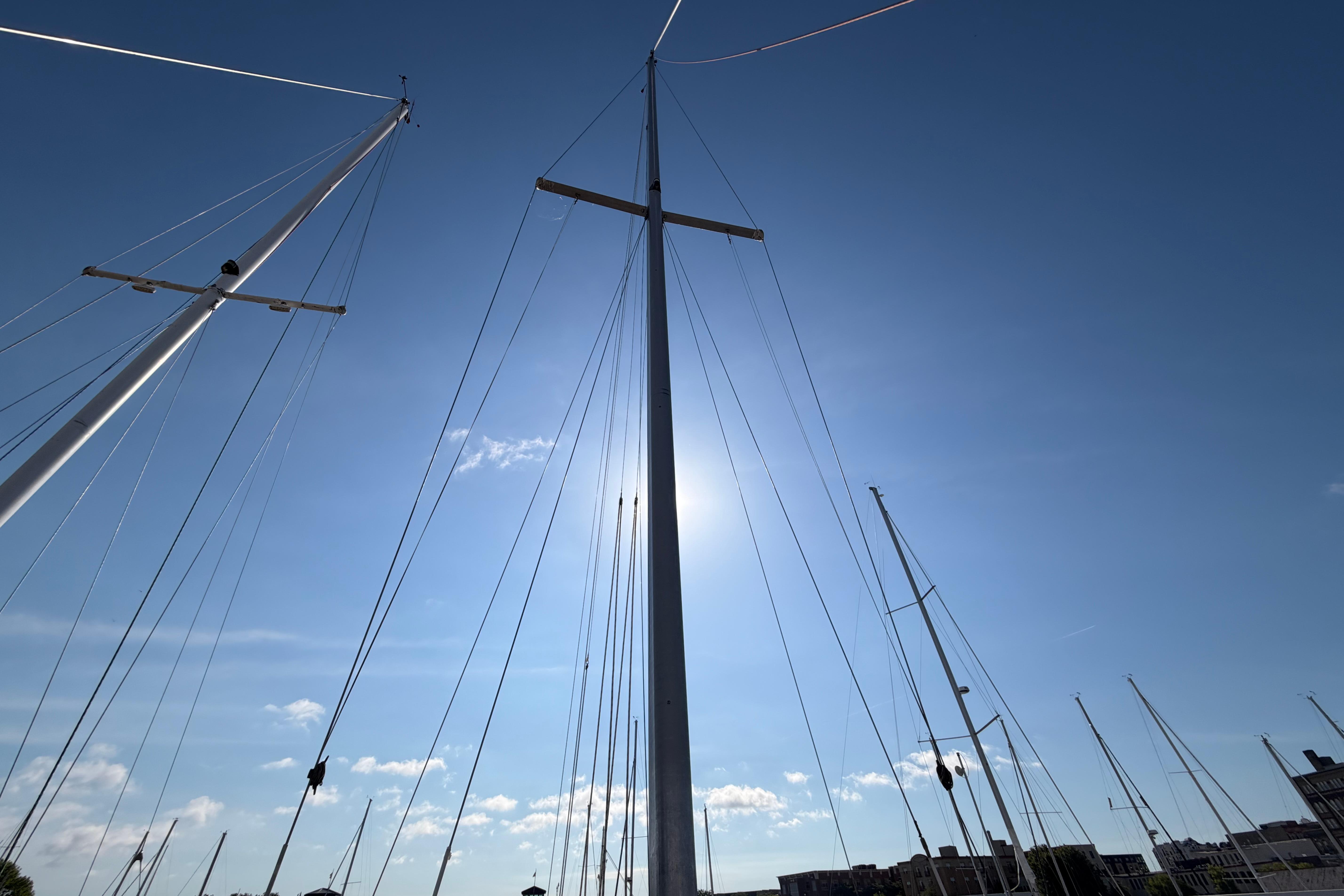Tall sailboat masts against a clear blue sky, Catalina 30 MkII, 1988 model.
