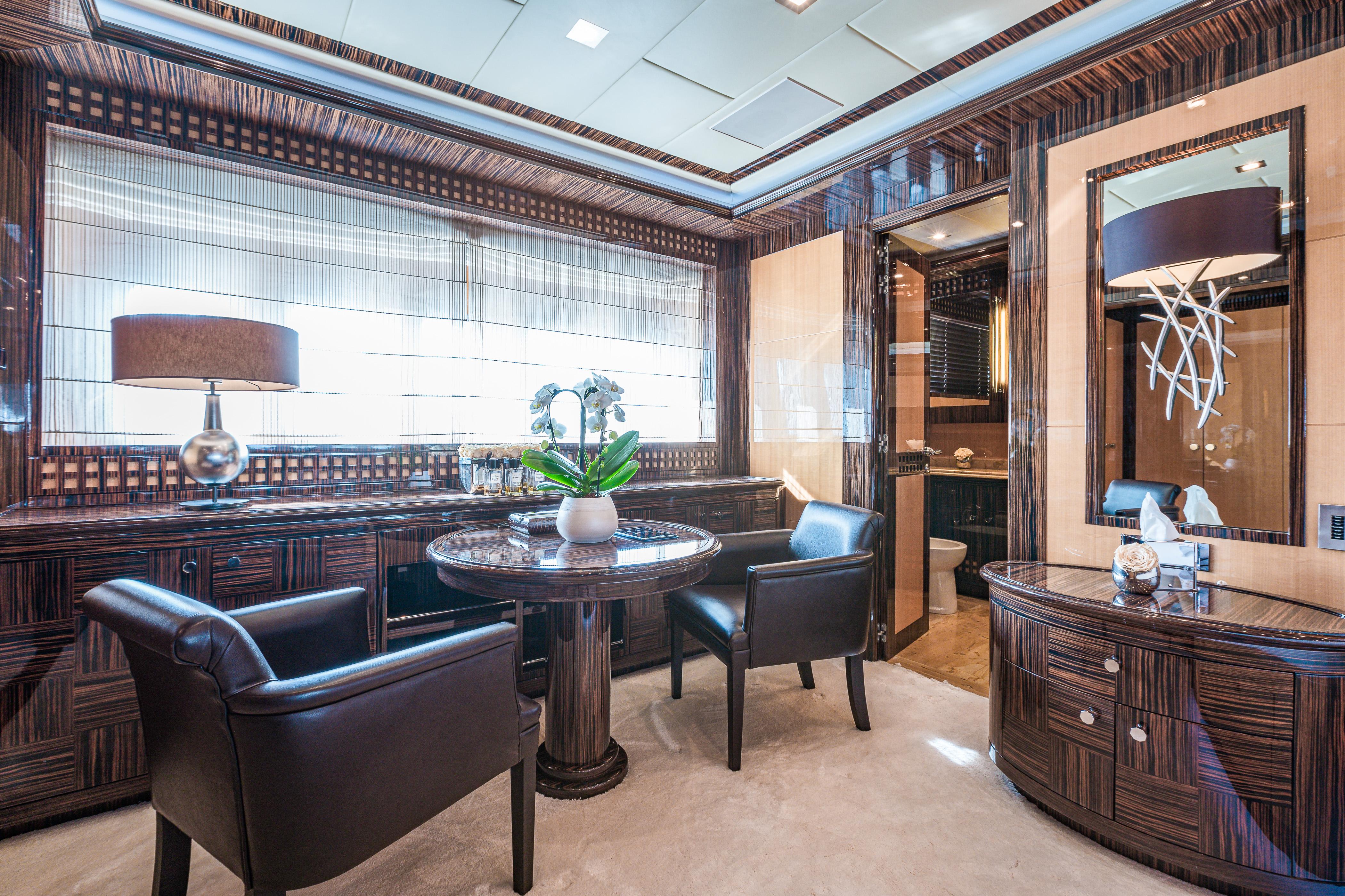 Luxurious interior of 2011 Mangusta 165 yacht with elegant seating and modern decor.