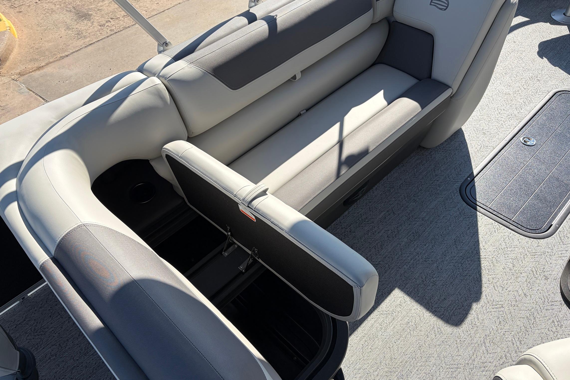 2026 Sun Tracker Fishin' Barge 22 XP3 interior with open storage compartment.