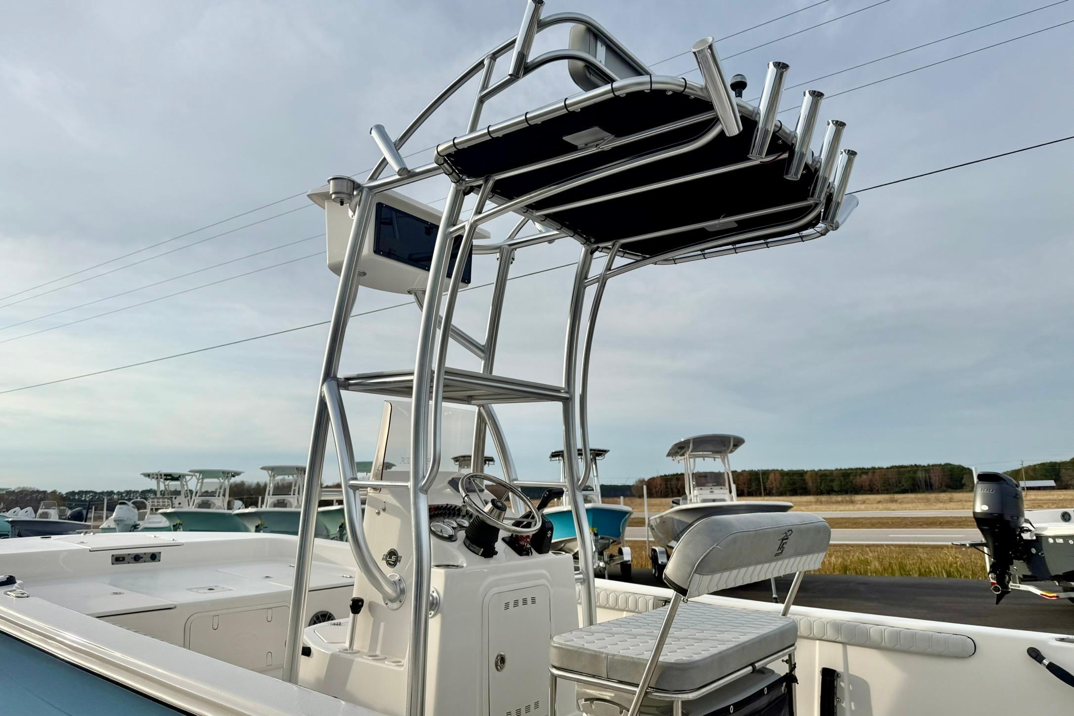2025 Carolina Skiff 21 LS boat with T-top and console, docked outdoors.