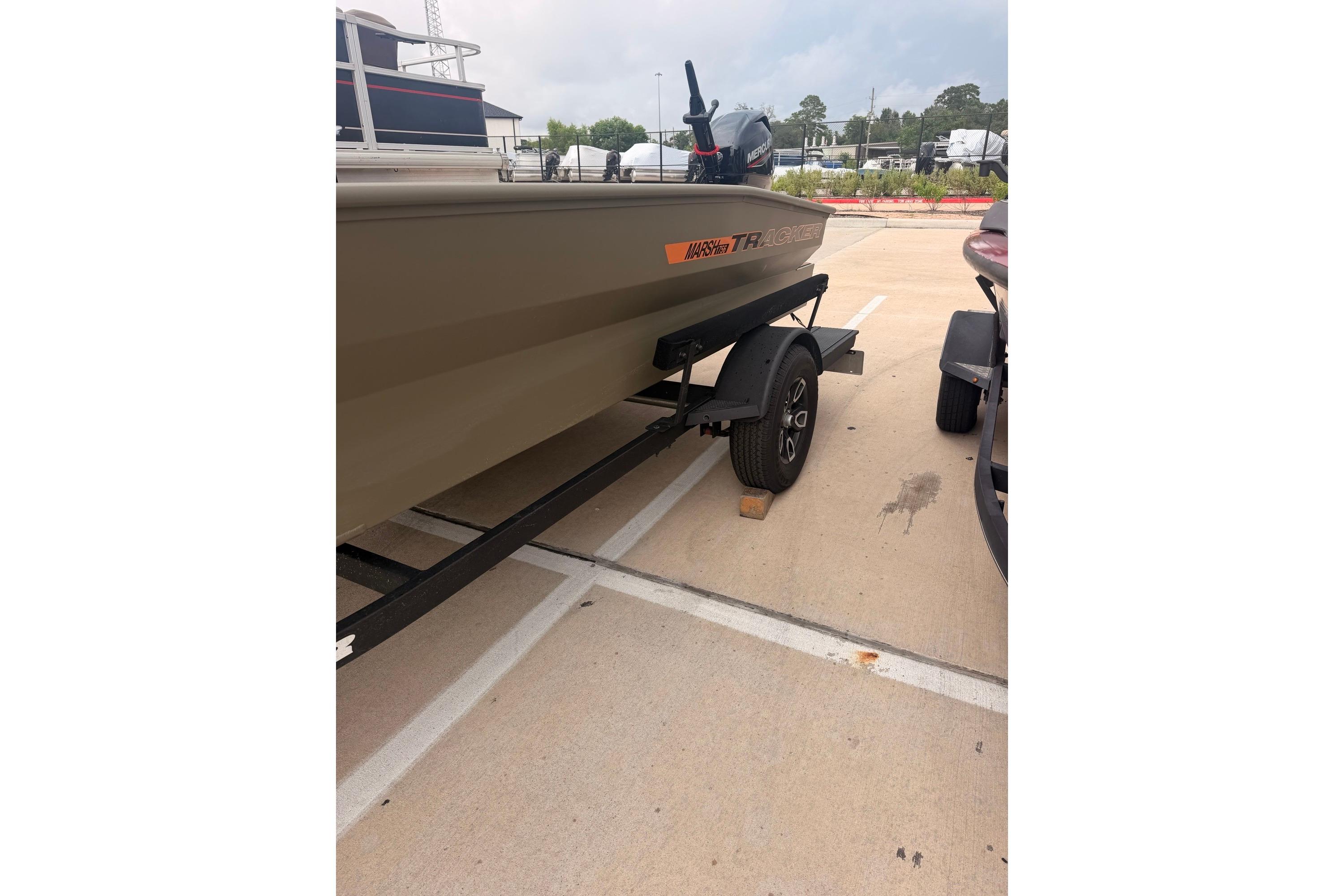 2026 Tracker Grizzly 1756 MARSH boat on trailer in parking lot.