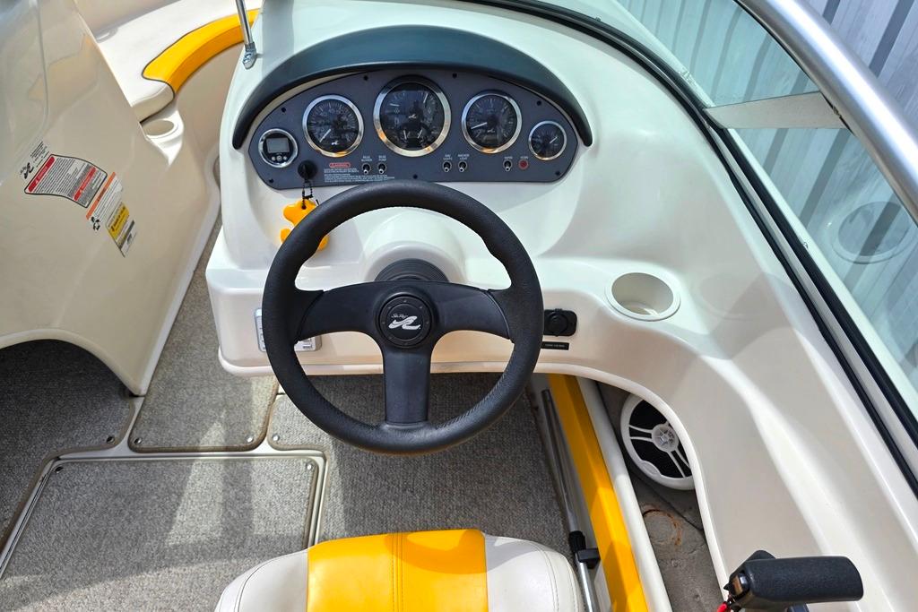 Interior view of 2007 Sea Ray 205 Sport boat dashboard and steering wheel.