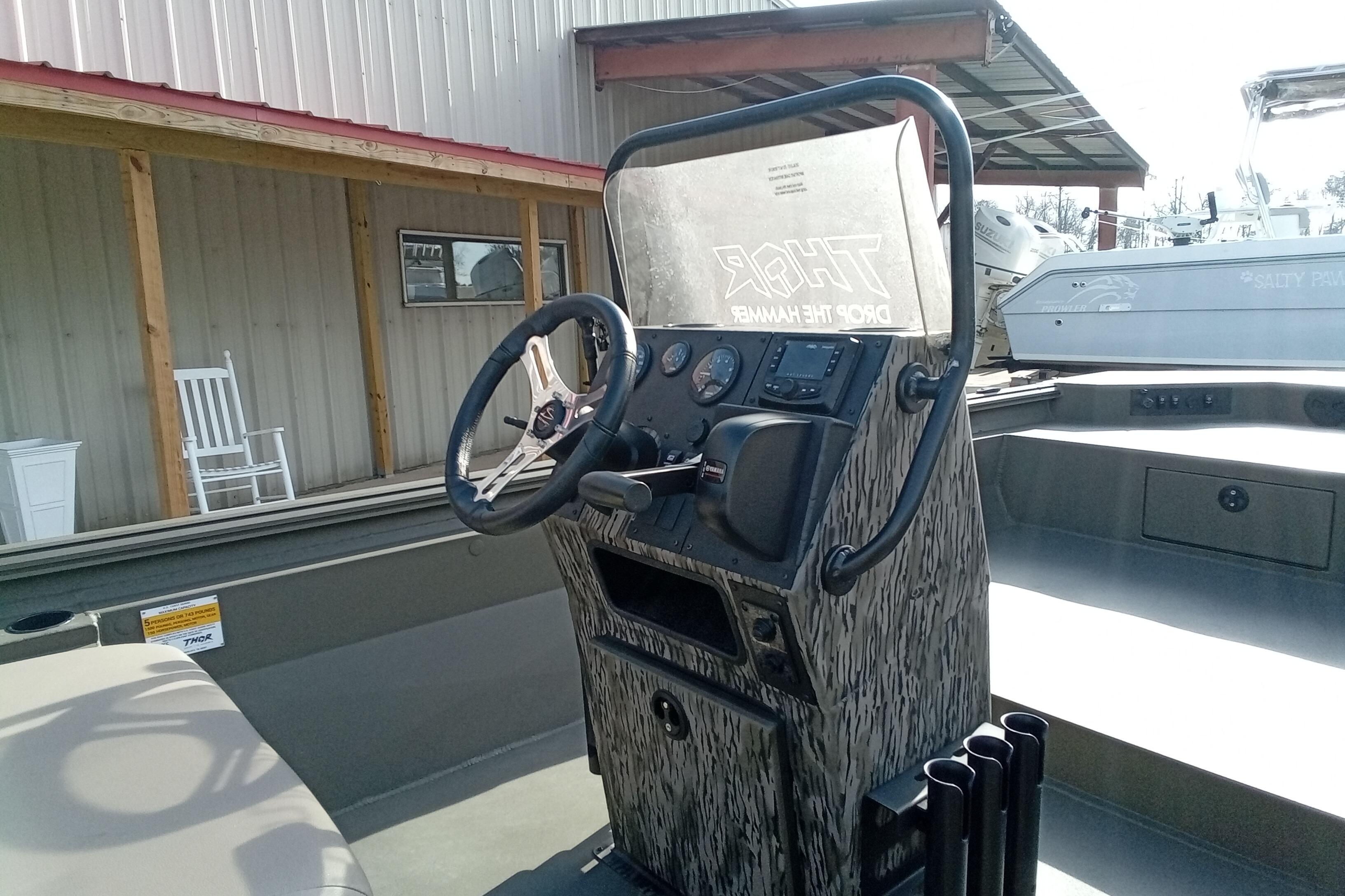 Steering console of 2026 Thor 1900 Low Country Elite boat, featuring camo design.