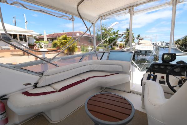 1992 Sea Ray 350 Express Bridge interior with white seating and helm station.