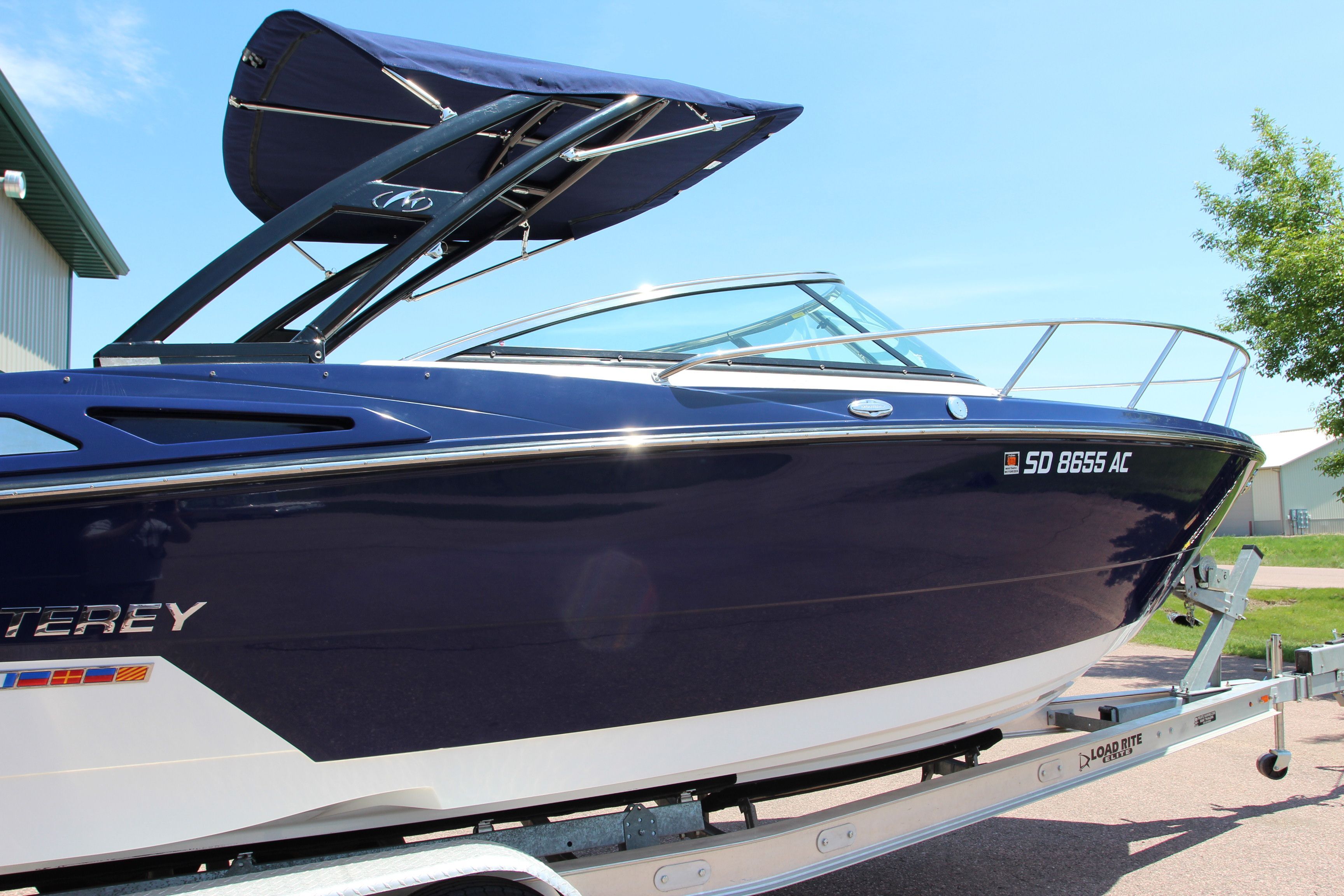 2015 Monterey 268SSC boat on trailer, blue hull, sunshade.