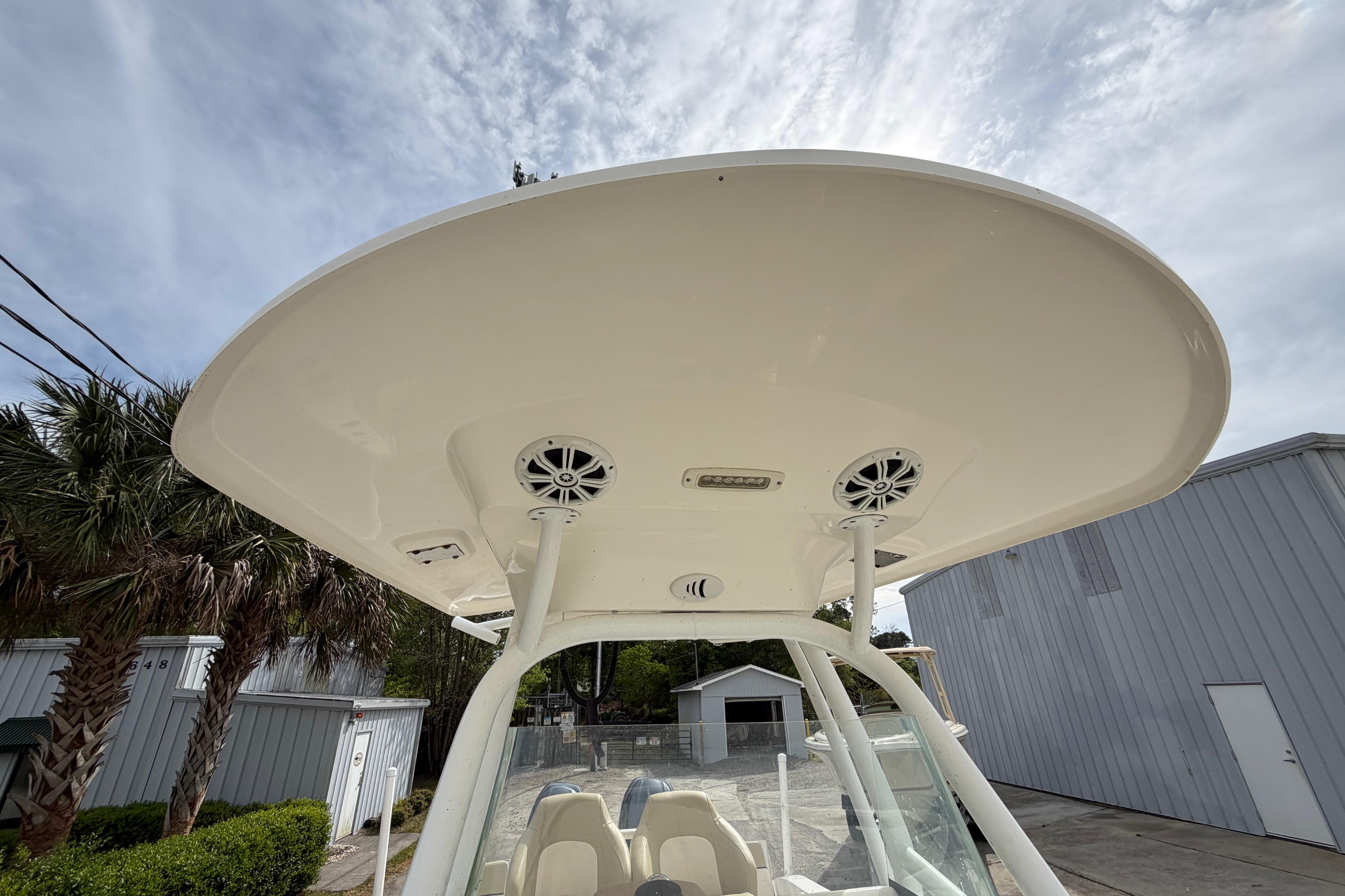 2015 Sea Fox 266 Commander boat with T-top and speakers, parked outdoors.
