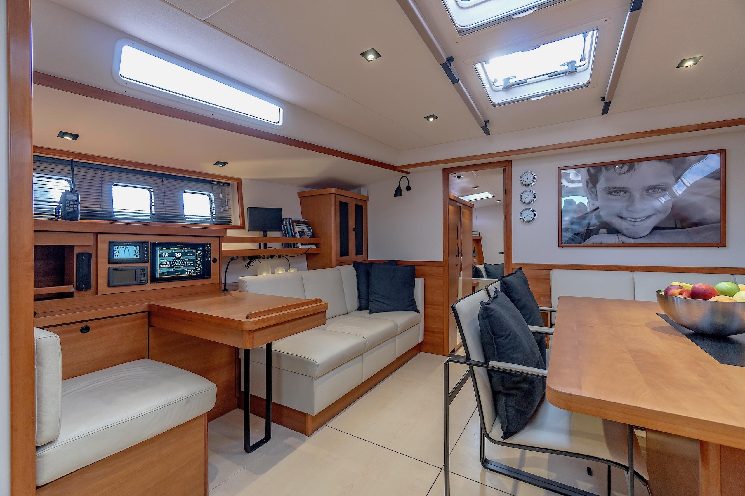 Luxurious interior of 2009 Hanse 630e yacht with modern seating and navigation equipment.