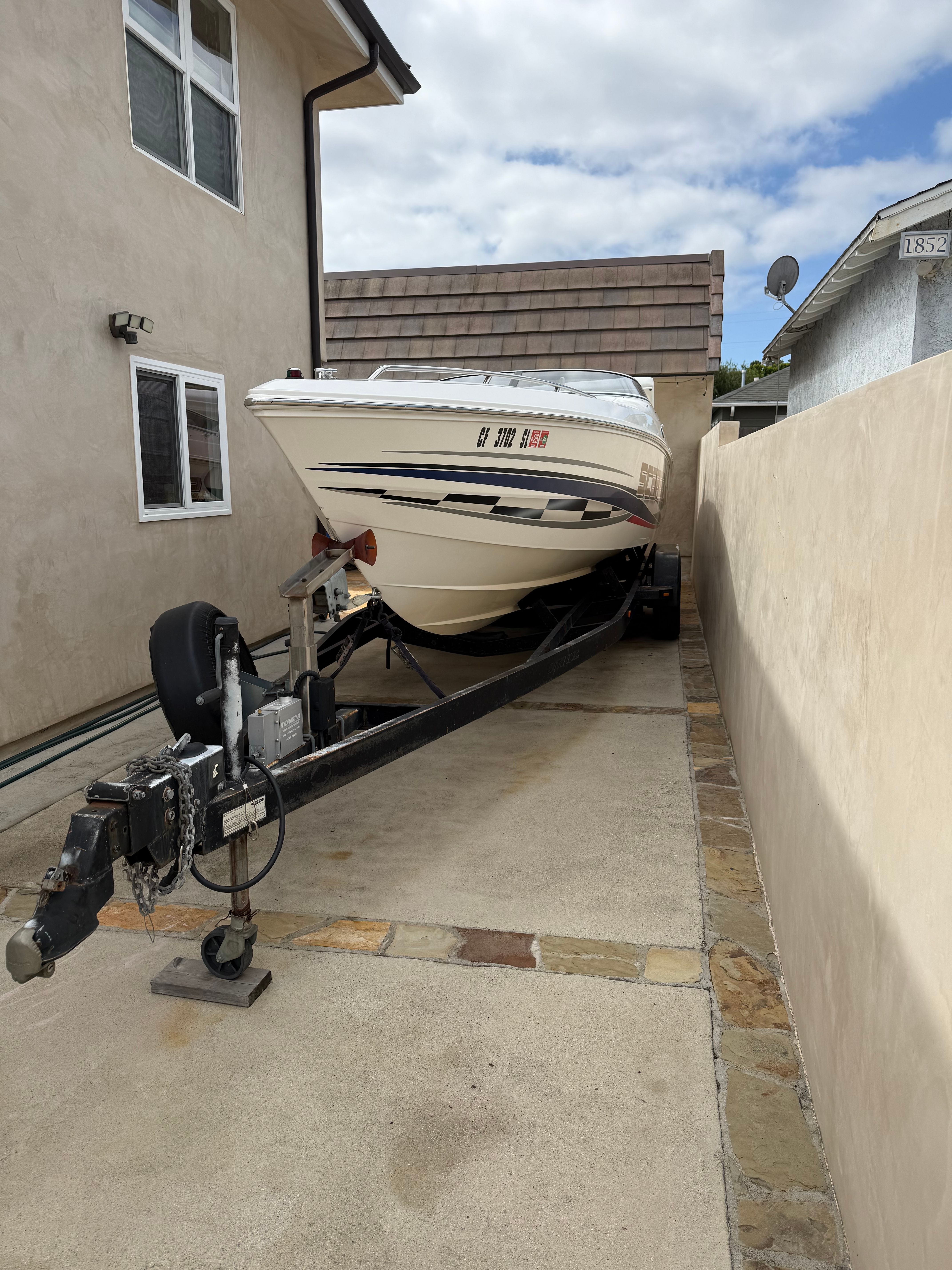 2001 Wellcraft 29 Scarab on trailer in driveway.