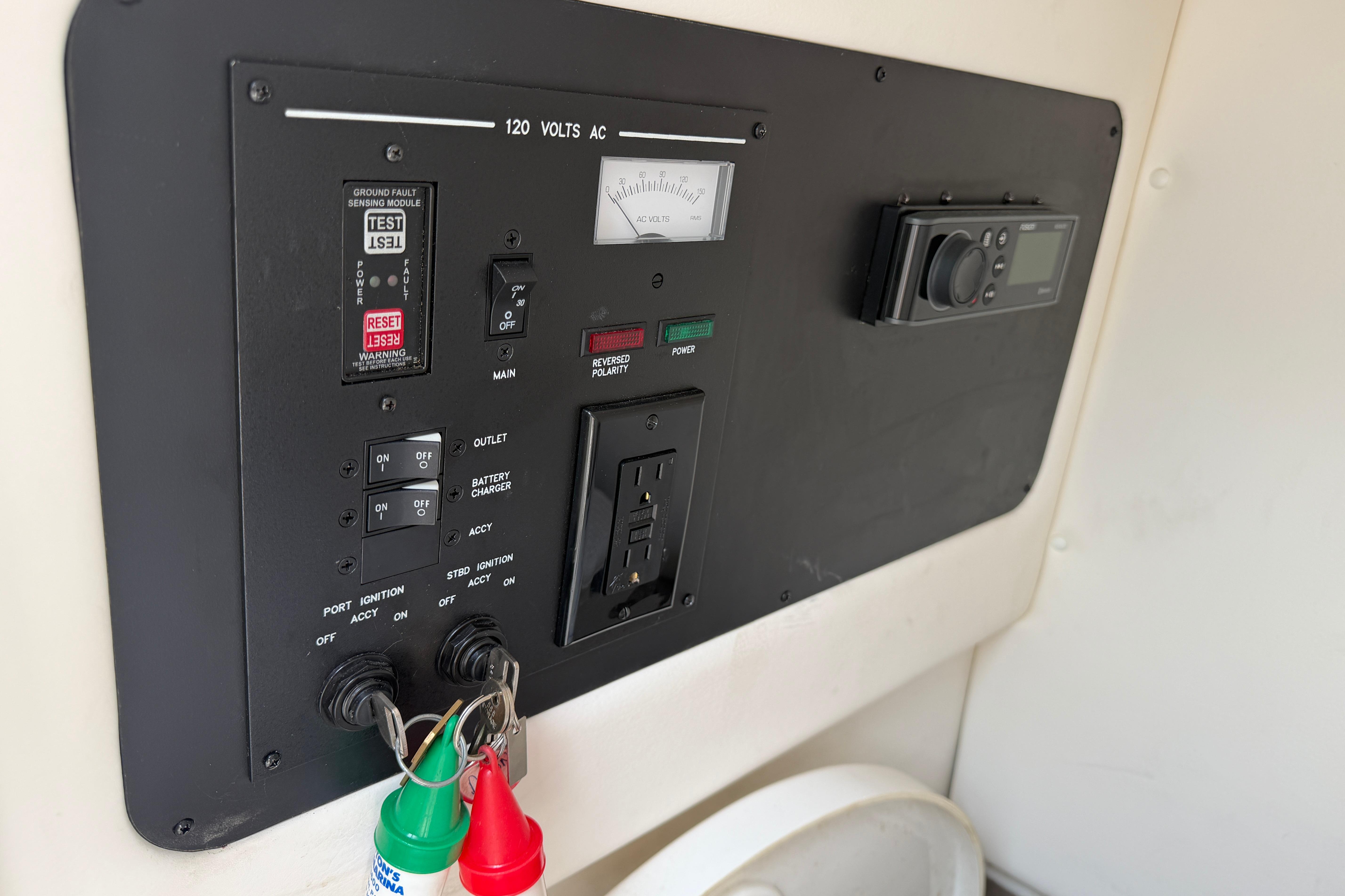 Control panel of a 2013 Sea Ray 300 SLX boat with various switches and gauges.
