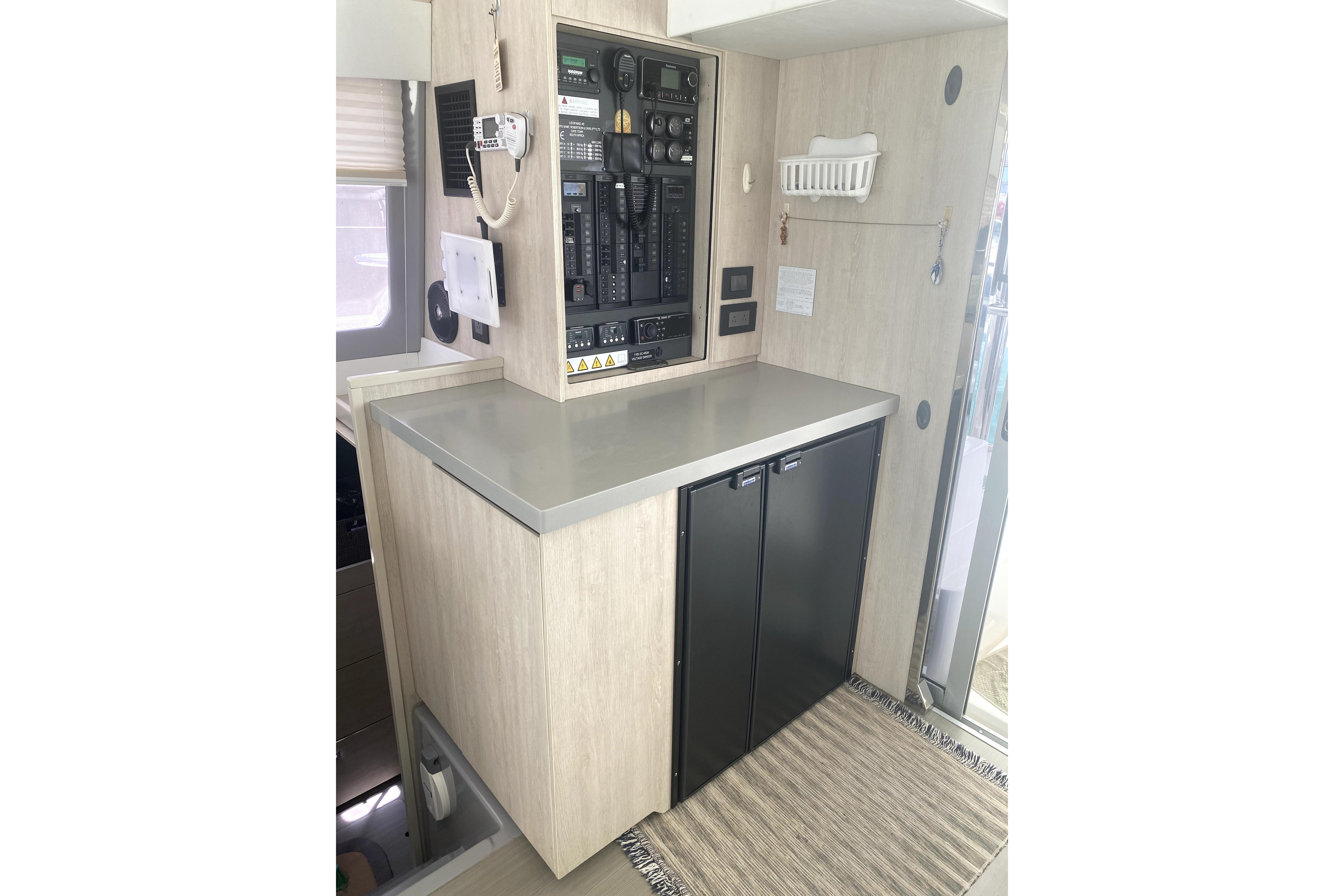 Control panel area in a 2017 Leopard 40 catamaran, featuring modern cabinetry and appliances.