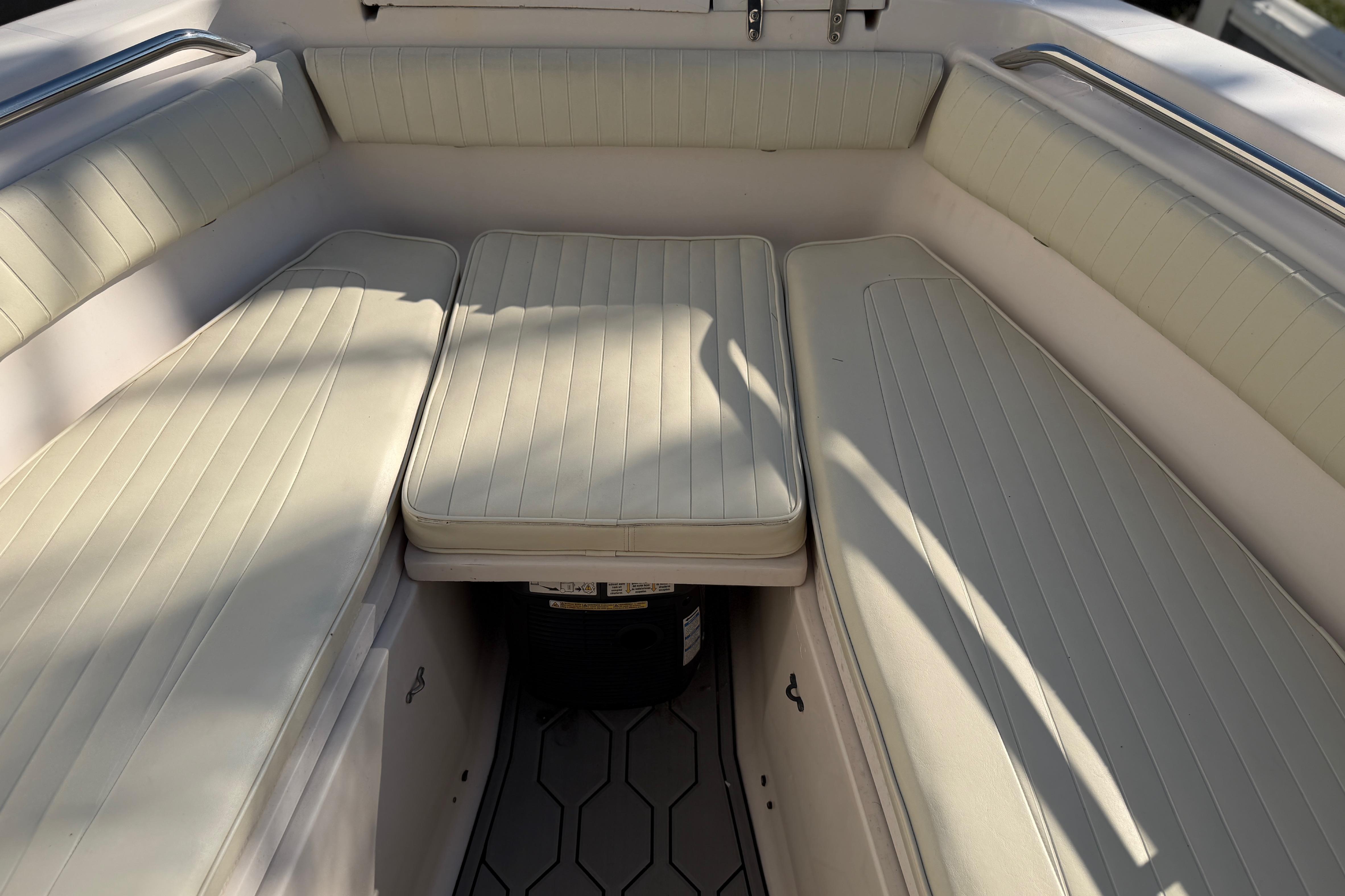 Interior seating of 2004 Grady White 273 boat with cushioned benches.