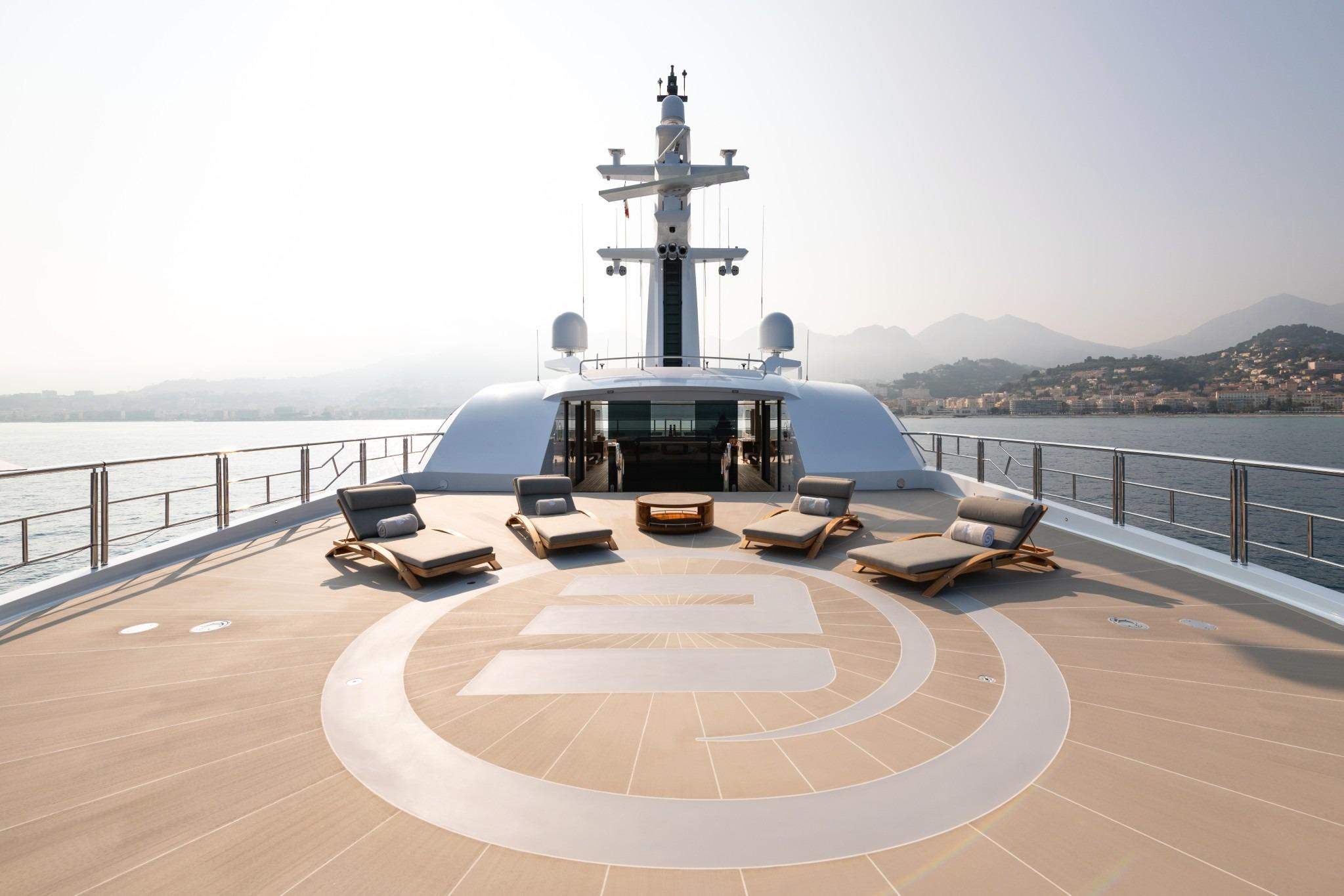 Luxurious 2022 Amels Custom yacht deck with sun loungers and scenic ocean view.