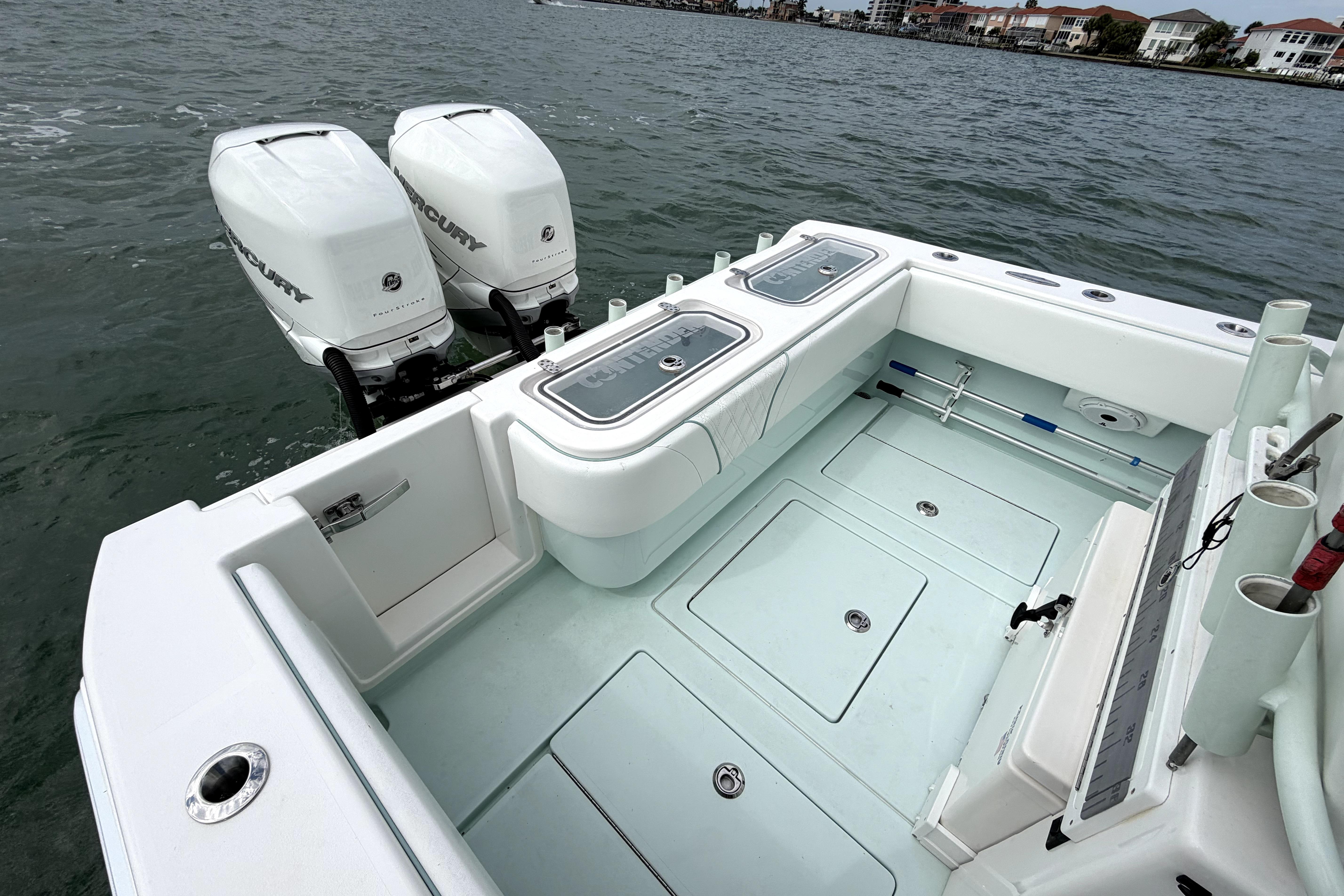 2019 Contender 30 ST boat with twin Mercury engines on calm water.