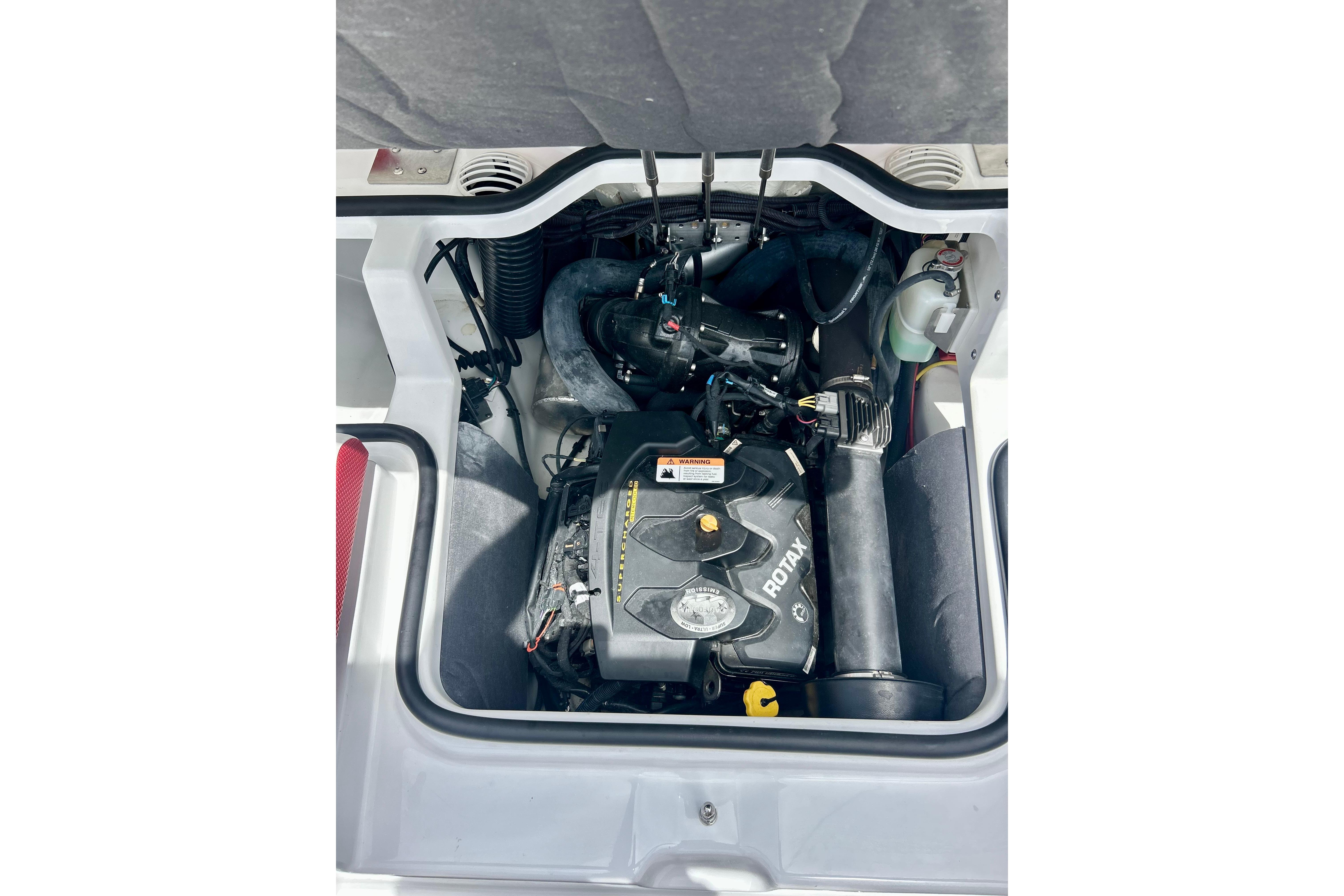 Engine compartment of 2021 Scarab 195 ID boat featuring a Rotax engine.
