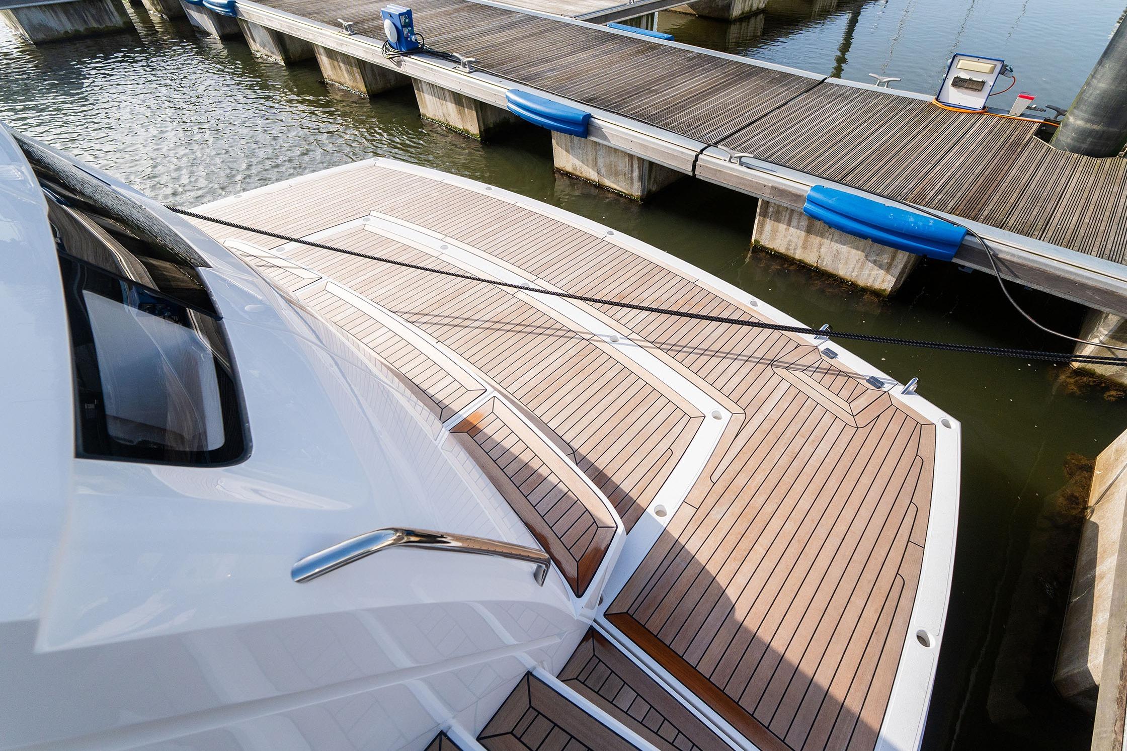 Luxury Sunseeker Manhattan 68 yacht docked, showcasing elegant teak deck design, 2026 model.