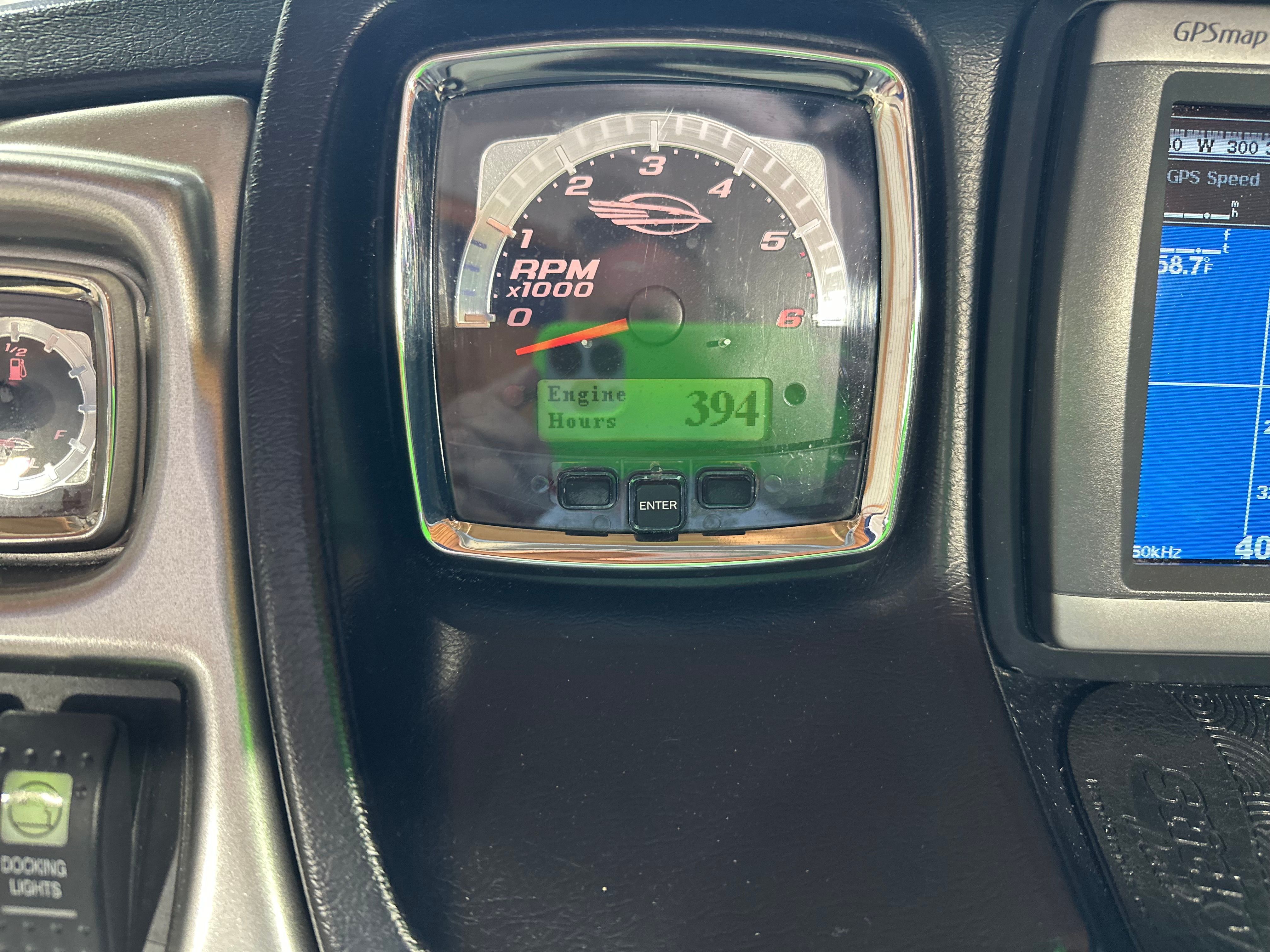 Close-up of a tachometer showing 394 engine hours on a 2011 Chaparral 287 SSX.