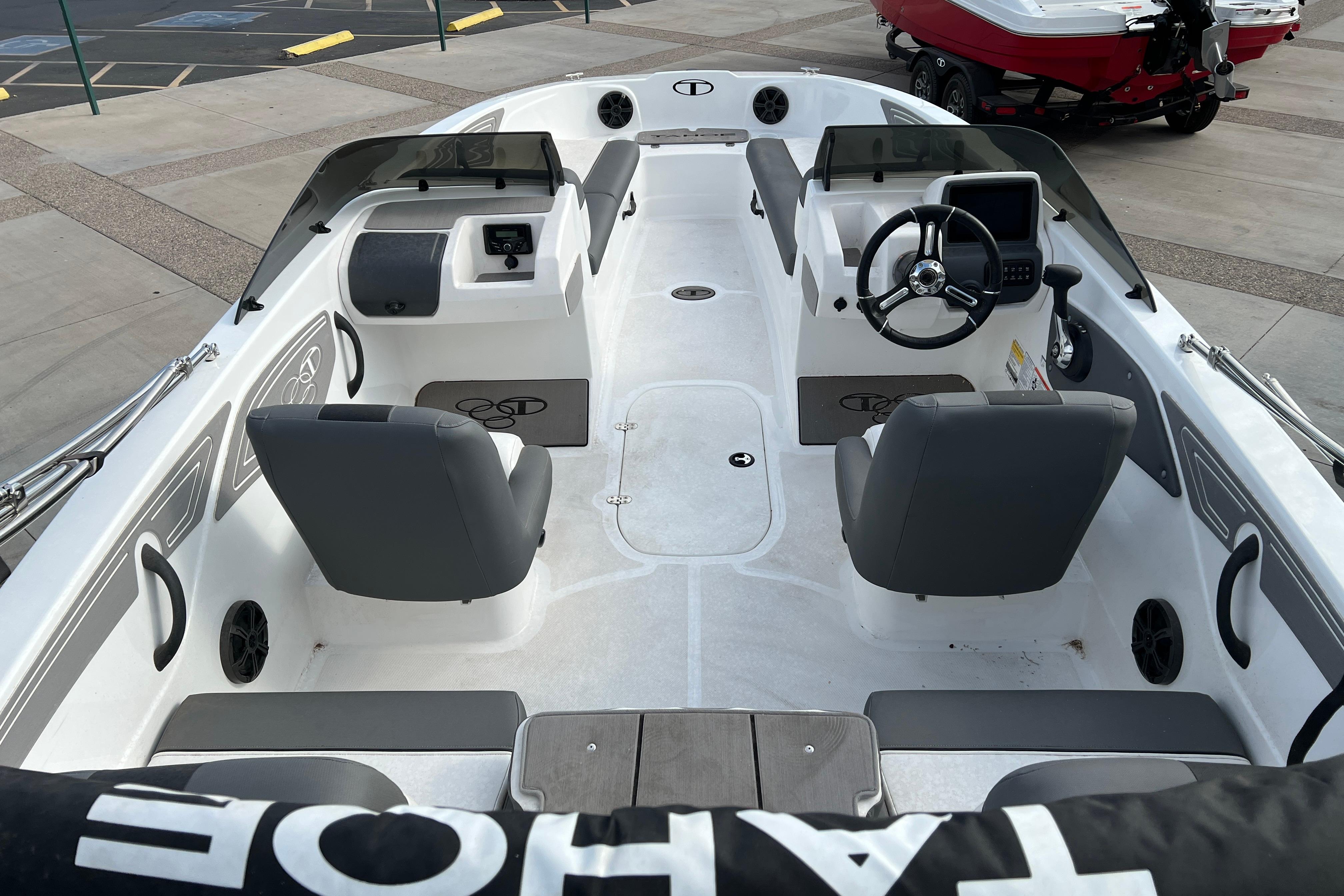 2026 Tahoe T21 boat interior with dual seating, steering wheel, and dashboard controls.