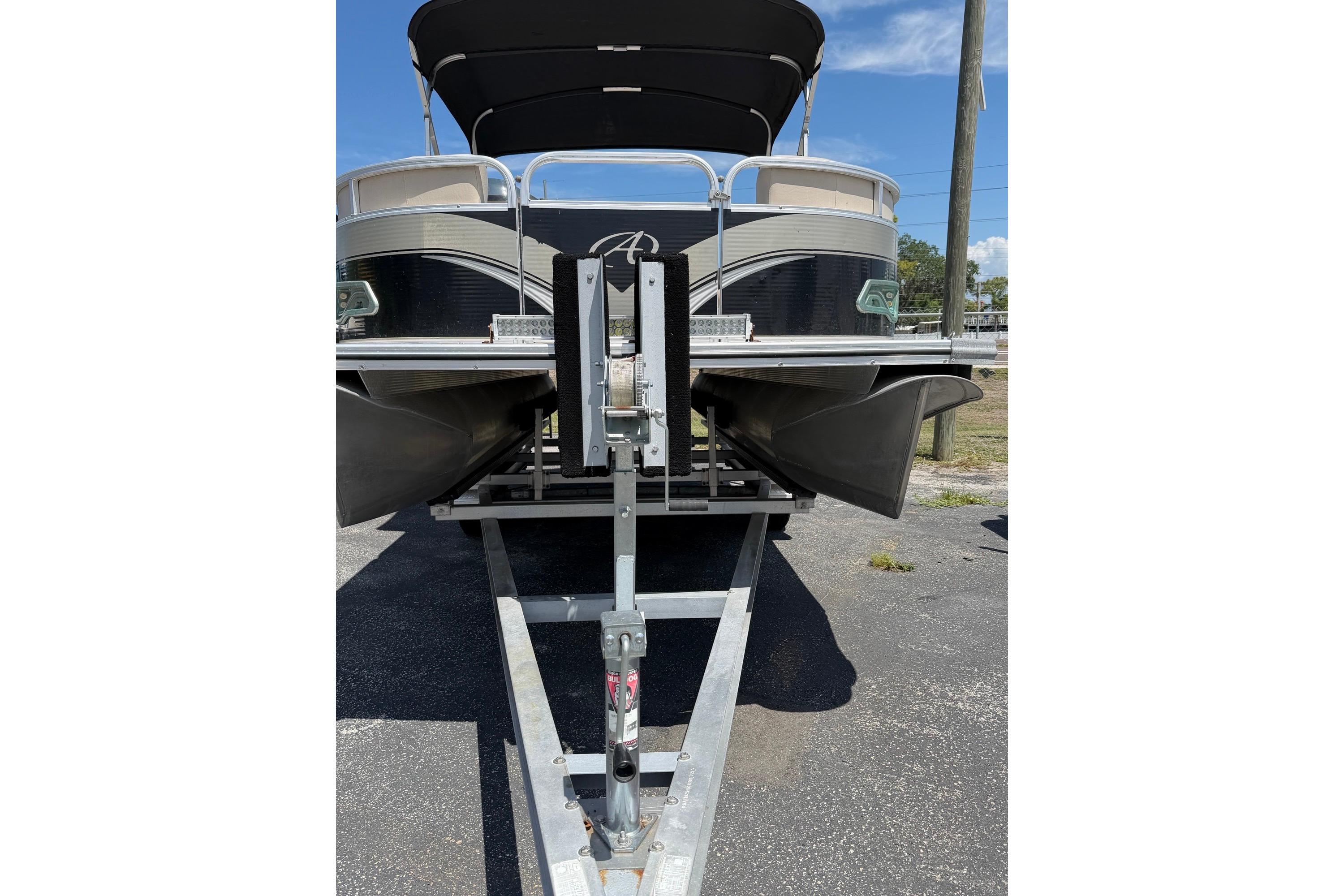 Front view of a 2014 Avalon 1900 pontoon boat on a trailer.