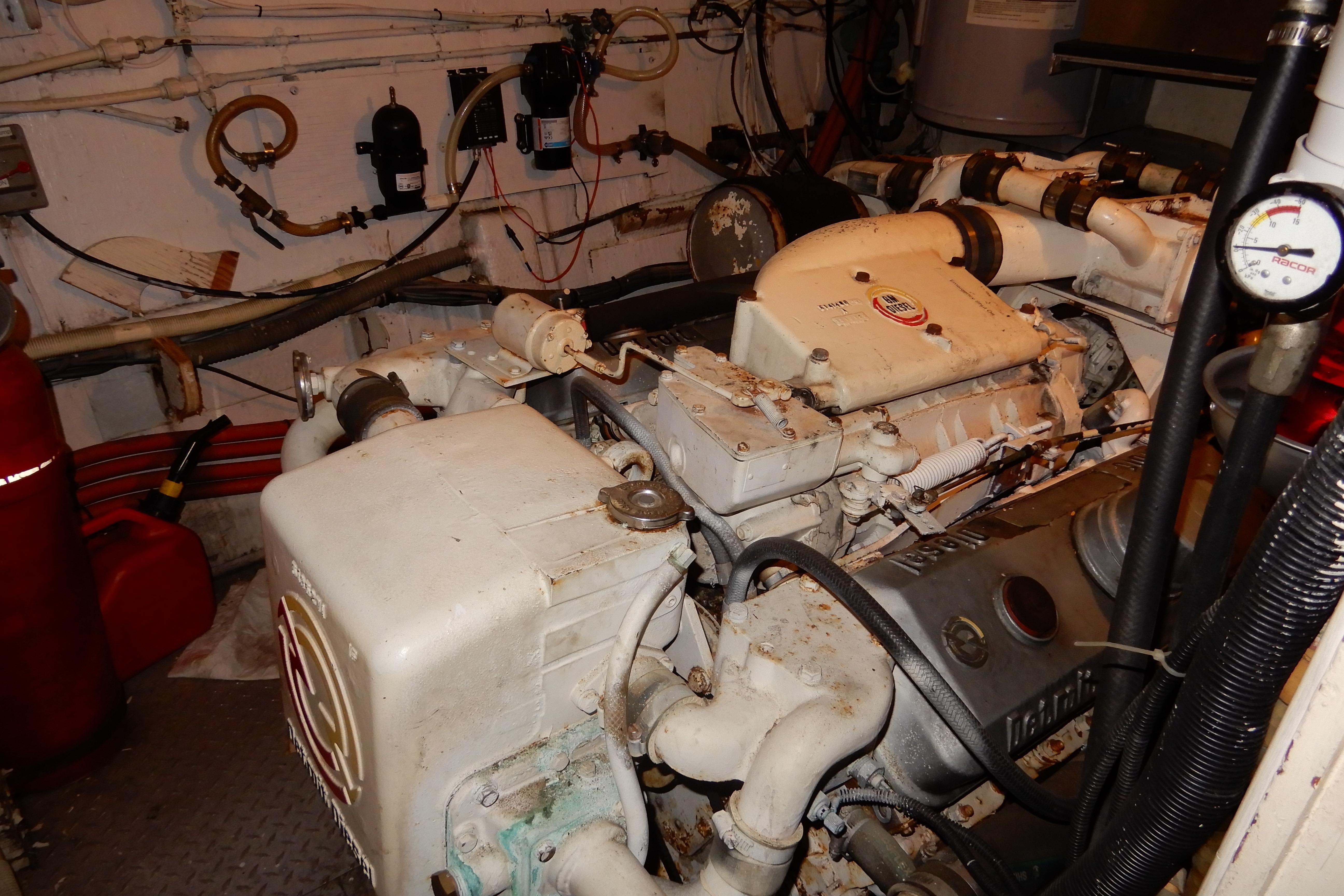 Engine room of a 1974 Hatteras 53 Motor Yacht with visible machinery and wiring.
