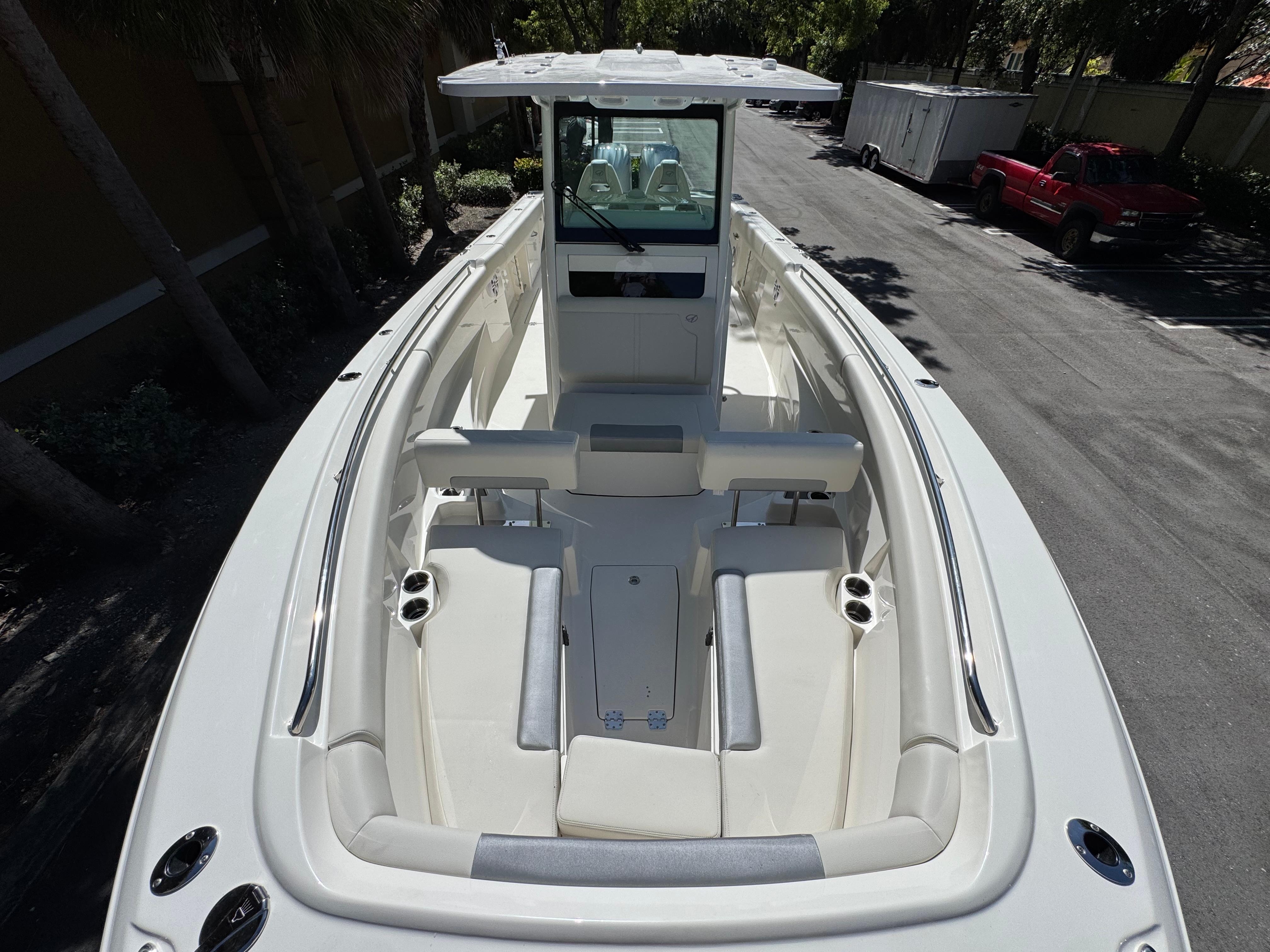 2026 Sailfish 312 CC boat, spacious seating, sleek design, parked outdoors.