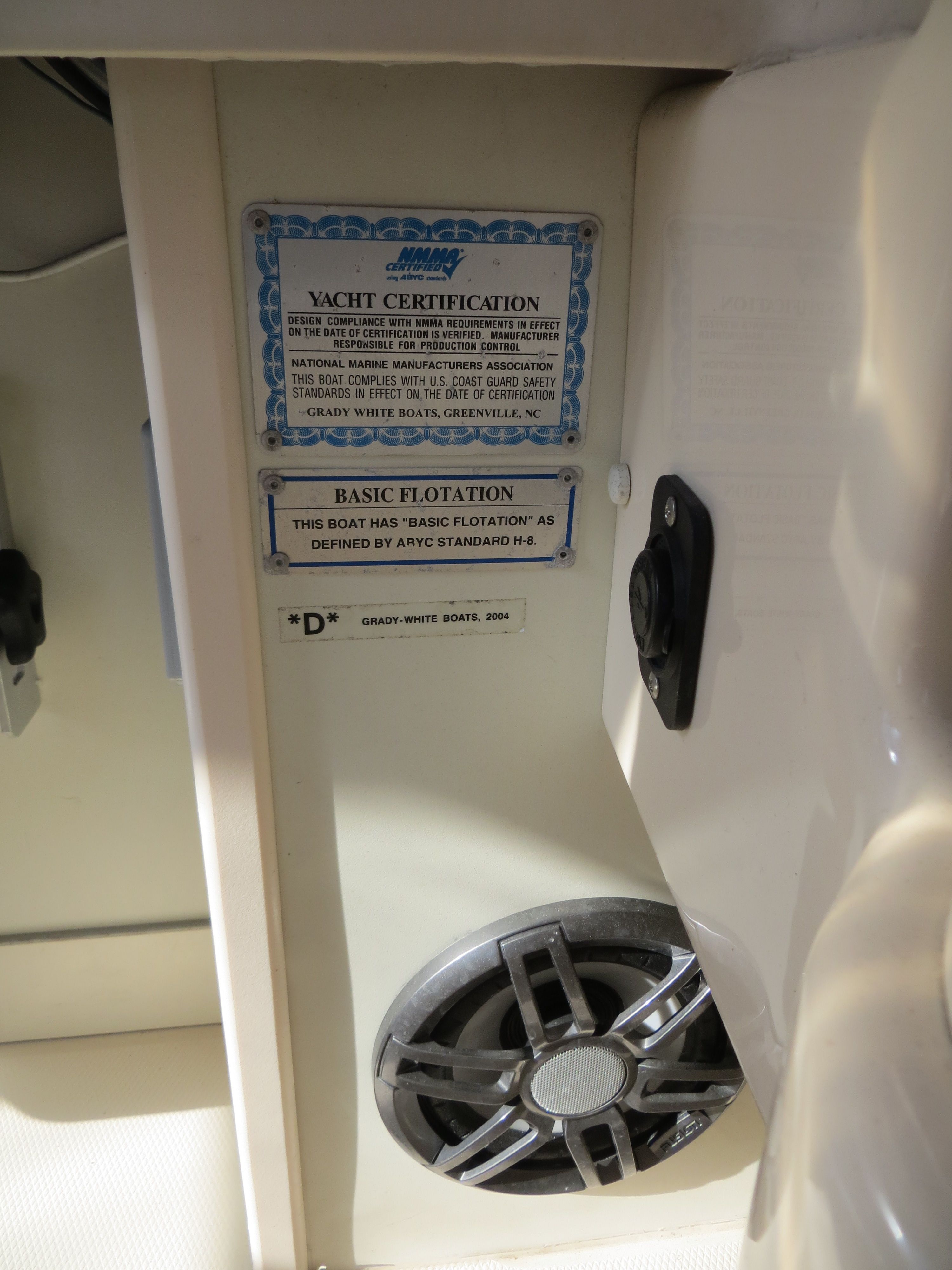 Close-up of a boat certification and speaker inside a 2007 Grady-White Sailfish 282.