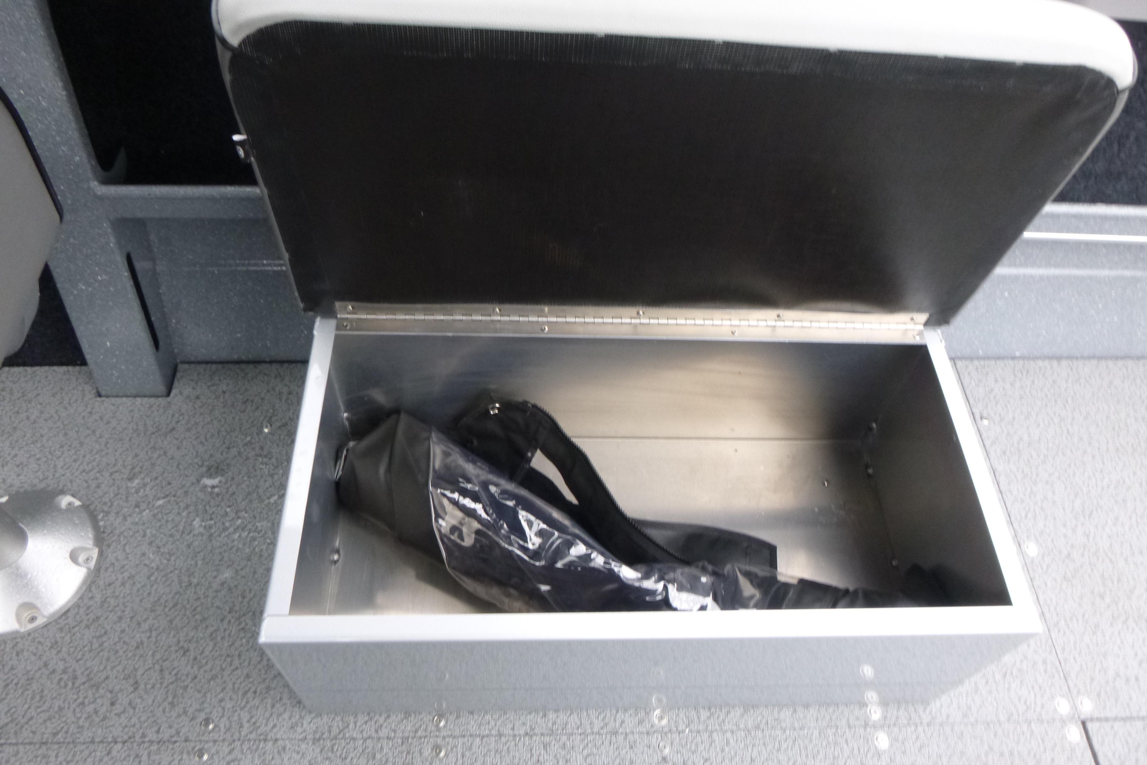 Open storage compartment in 2026 KingFisher 2025 Escape boat, featuring a black interior bag.
