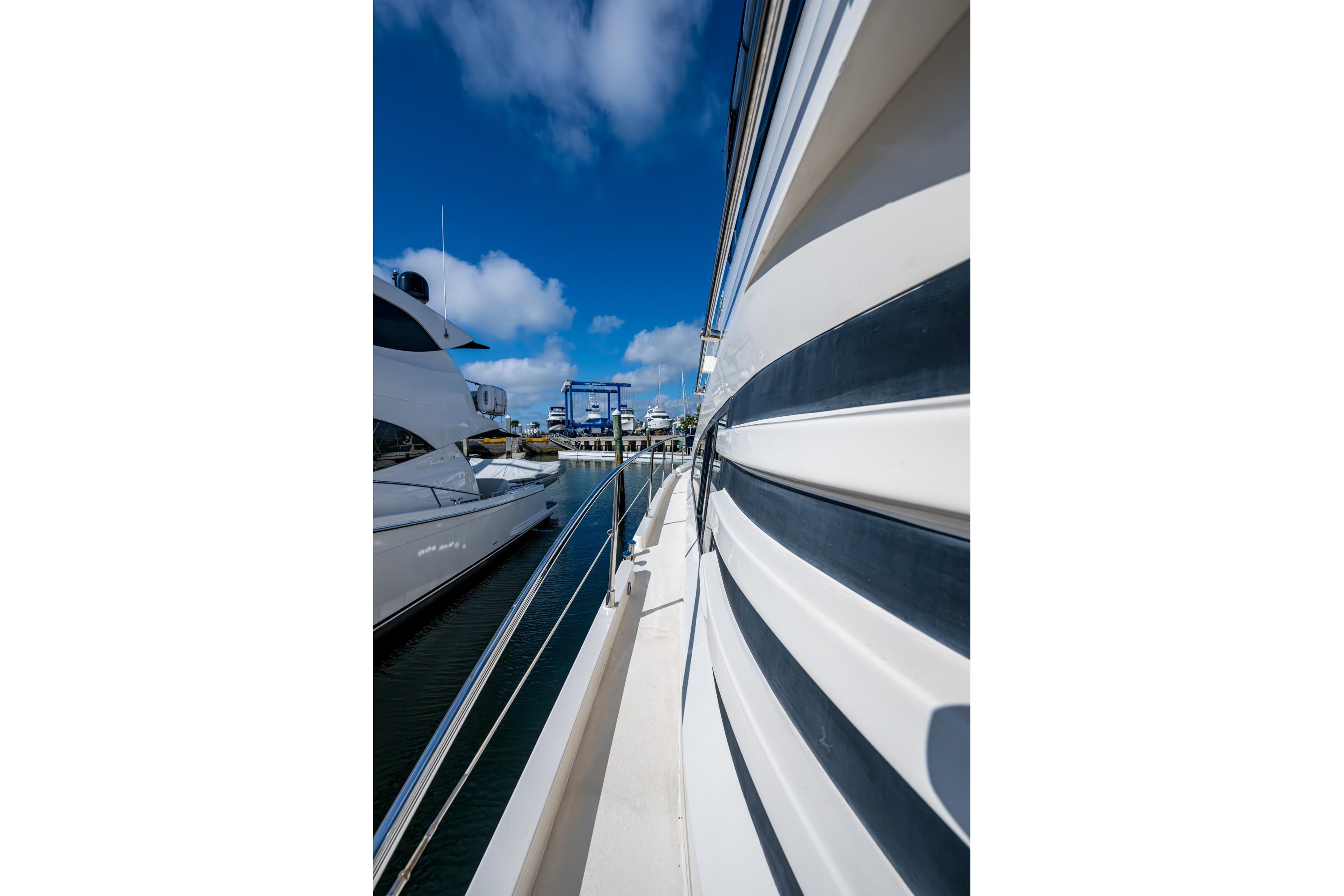 Side view of a 2000 Fairline Squadron 52 yacht docked at a marina.