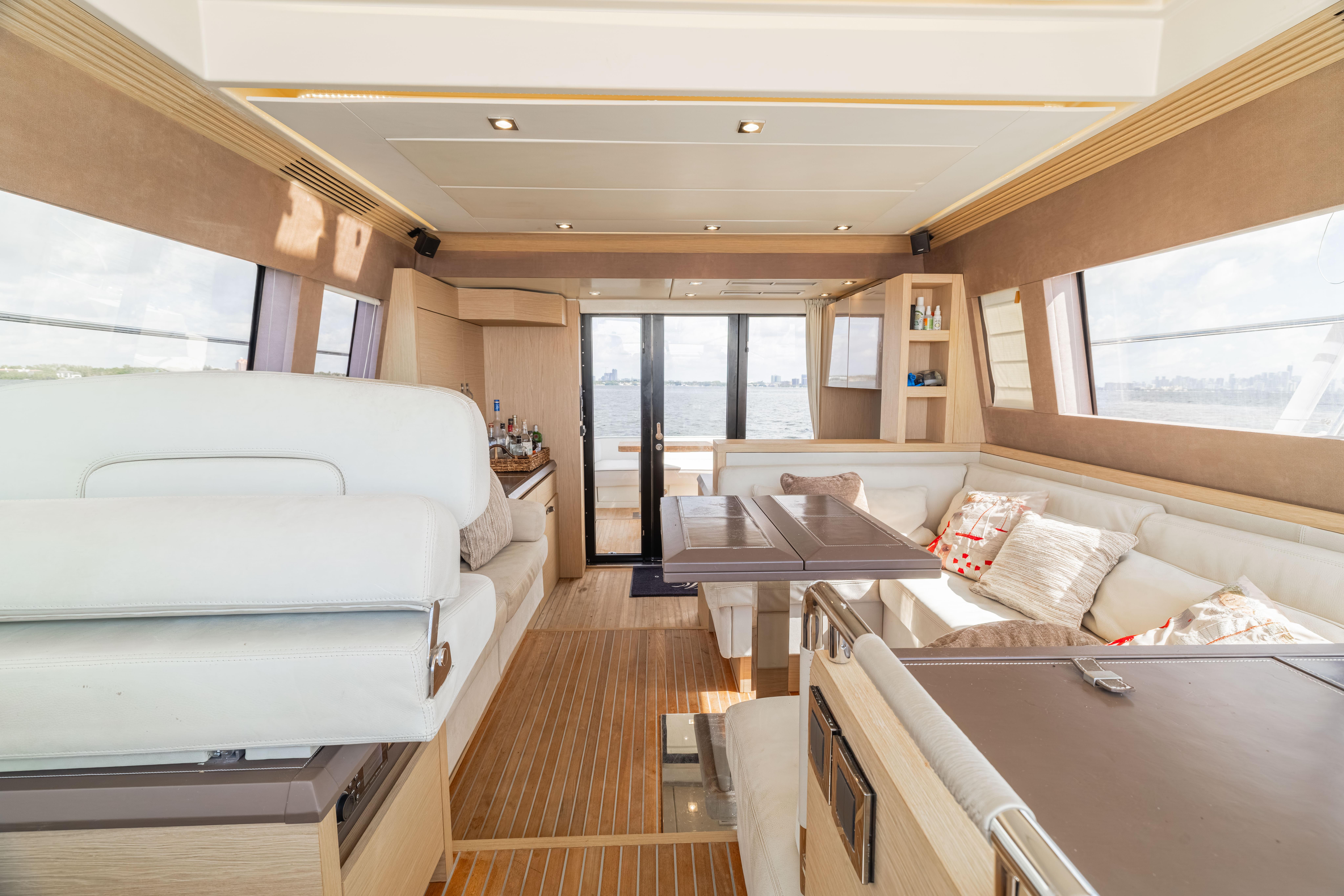 Luxurious interior of 2017 Monte Carlo Yachts MC5 with elegant seating and panoramic windows.