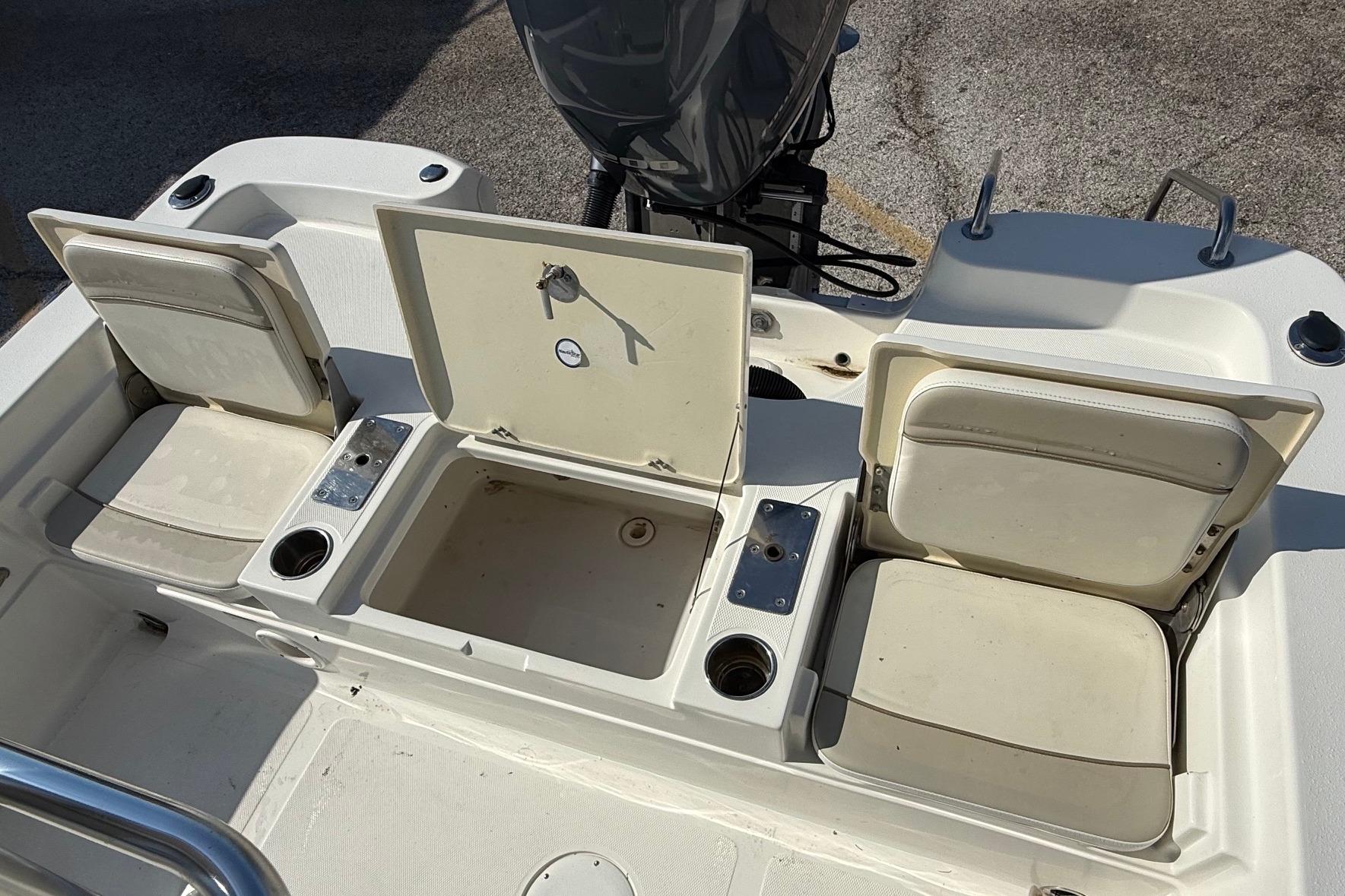 2015 NauticStar 224 XTS boat interior with open storage compartments and seating.