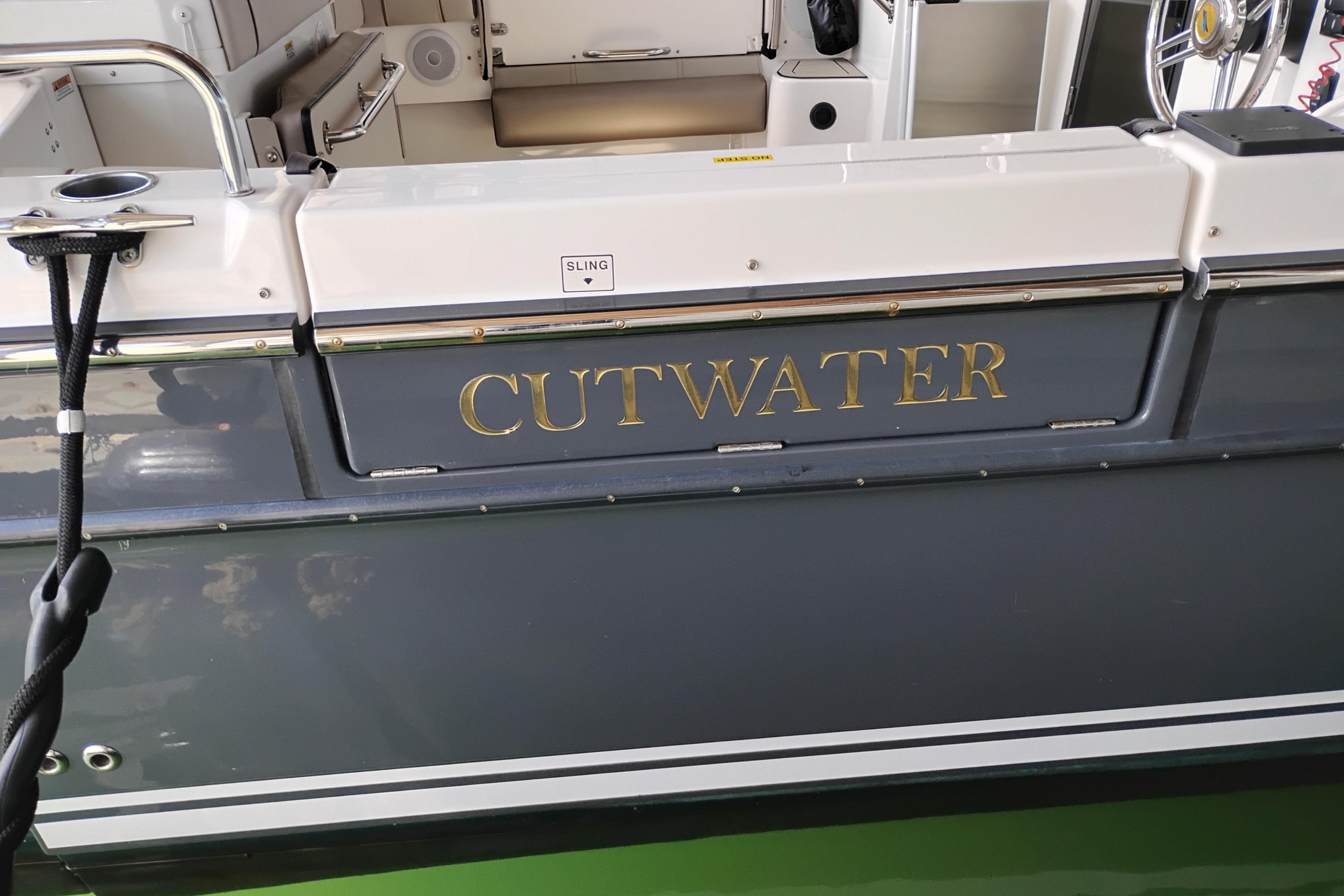 2022 Cutwater C-32 Coupe boat with sleek design and gold lettering.