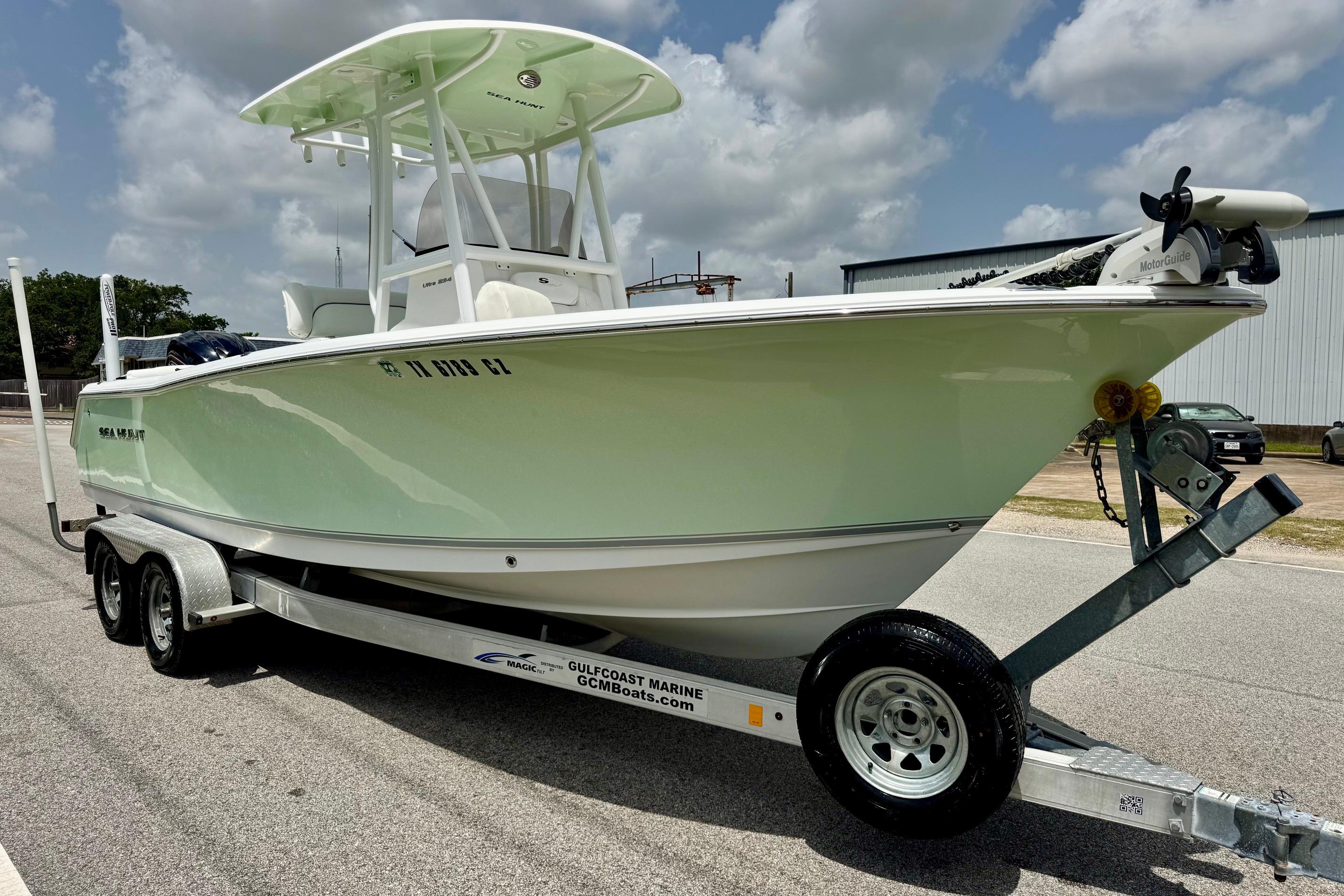 2015 Sea Hunt Ultra 234 boat on trailer under cloudy sky.