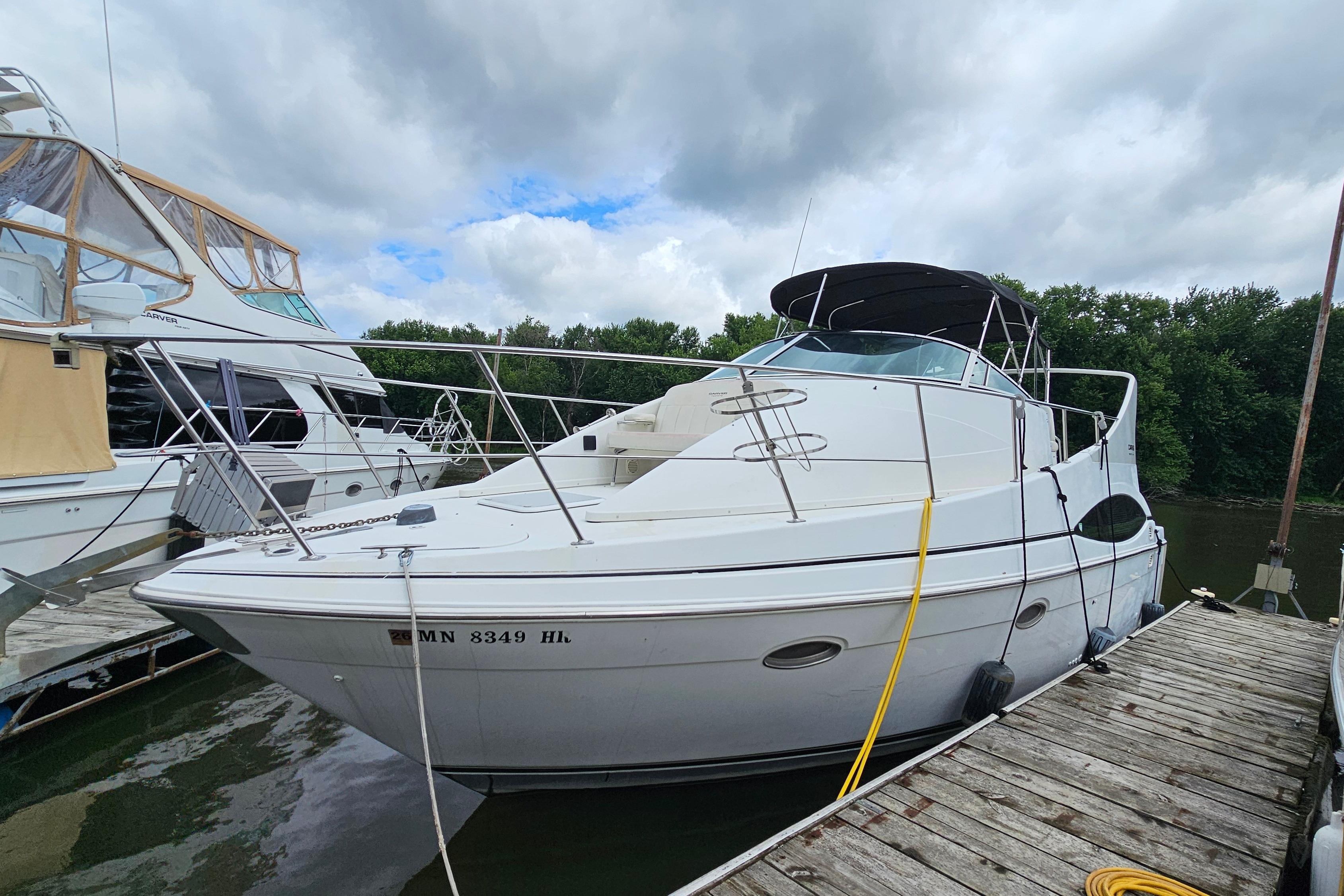 1999 Carver 350 Mariner yacht docked, featuring sleek design and spacious deck.