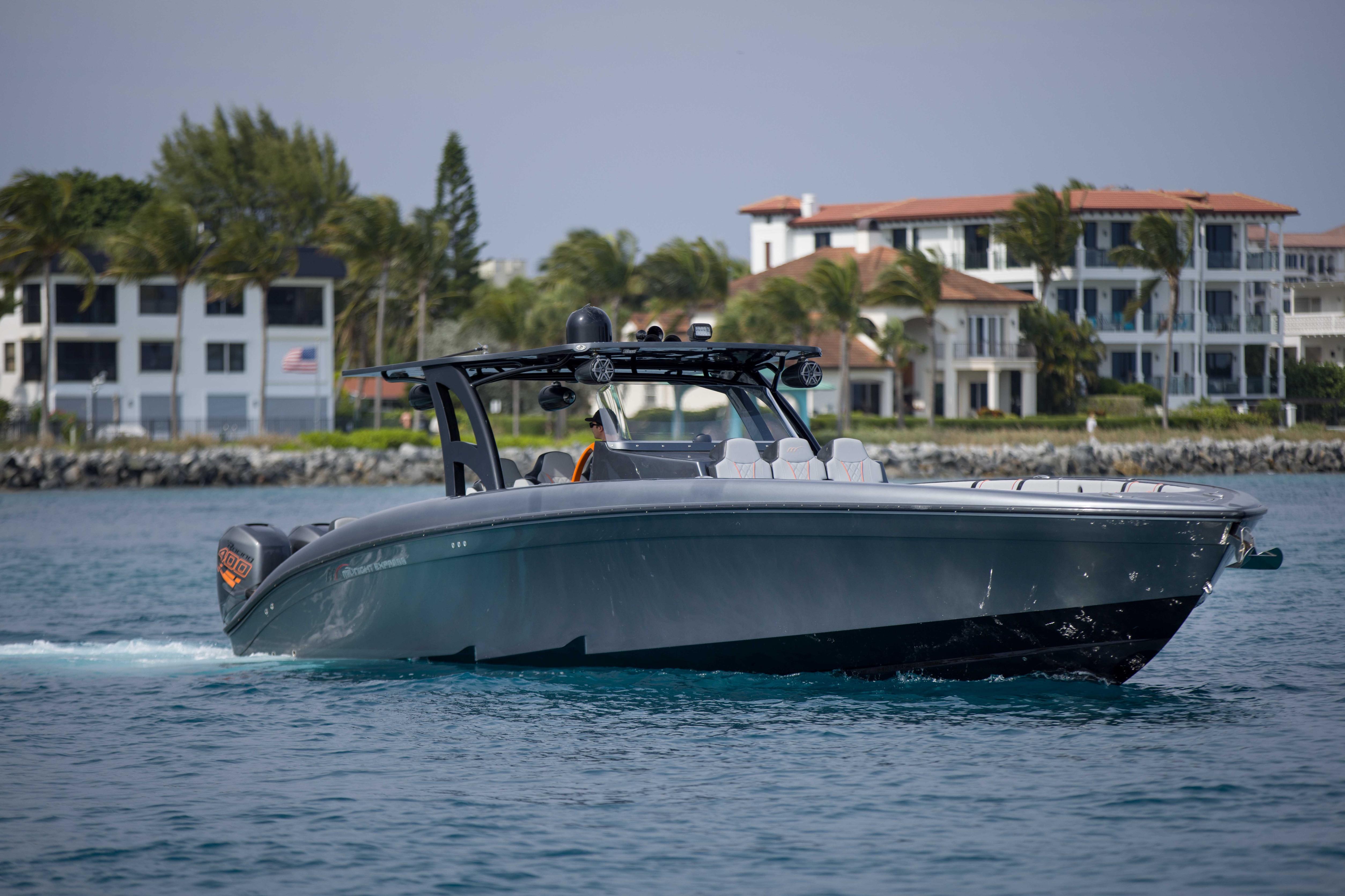 2019 Midnight Express 43 Open boat cruising near luxury waterfront homes.