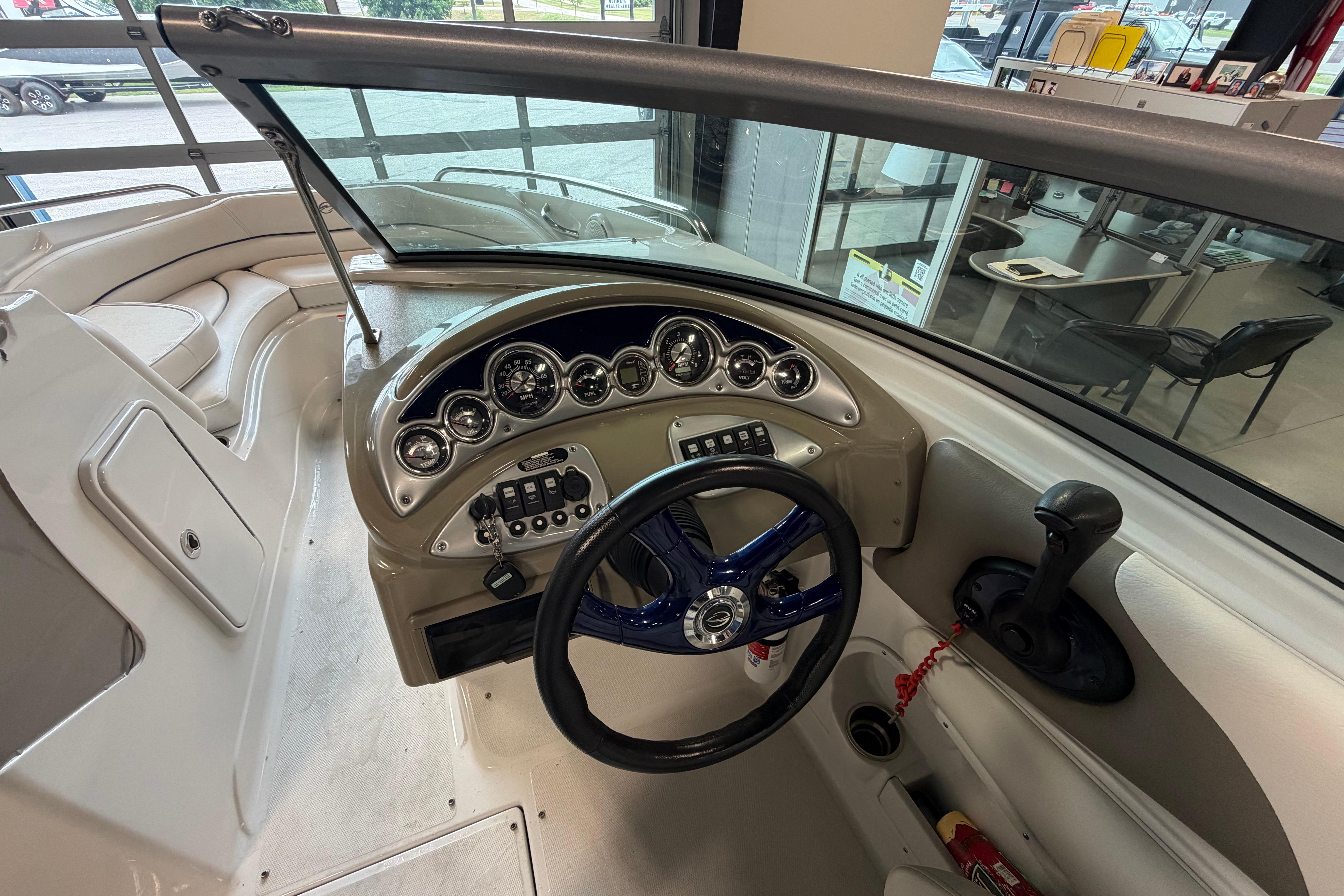 2008 Crownline 220 LS boat dashboard with steering wheel and control panel.