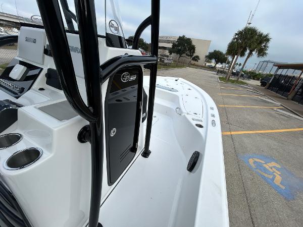2024 Sea Pro 250 DLX boat, sleek design, docked in a parking area.