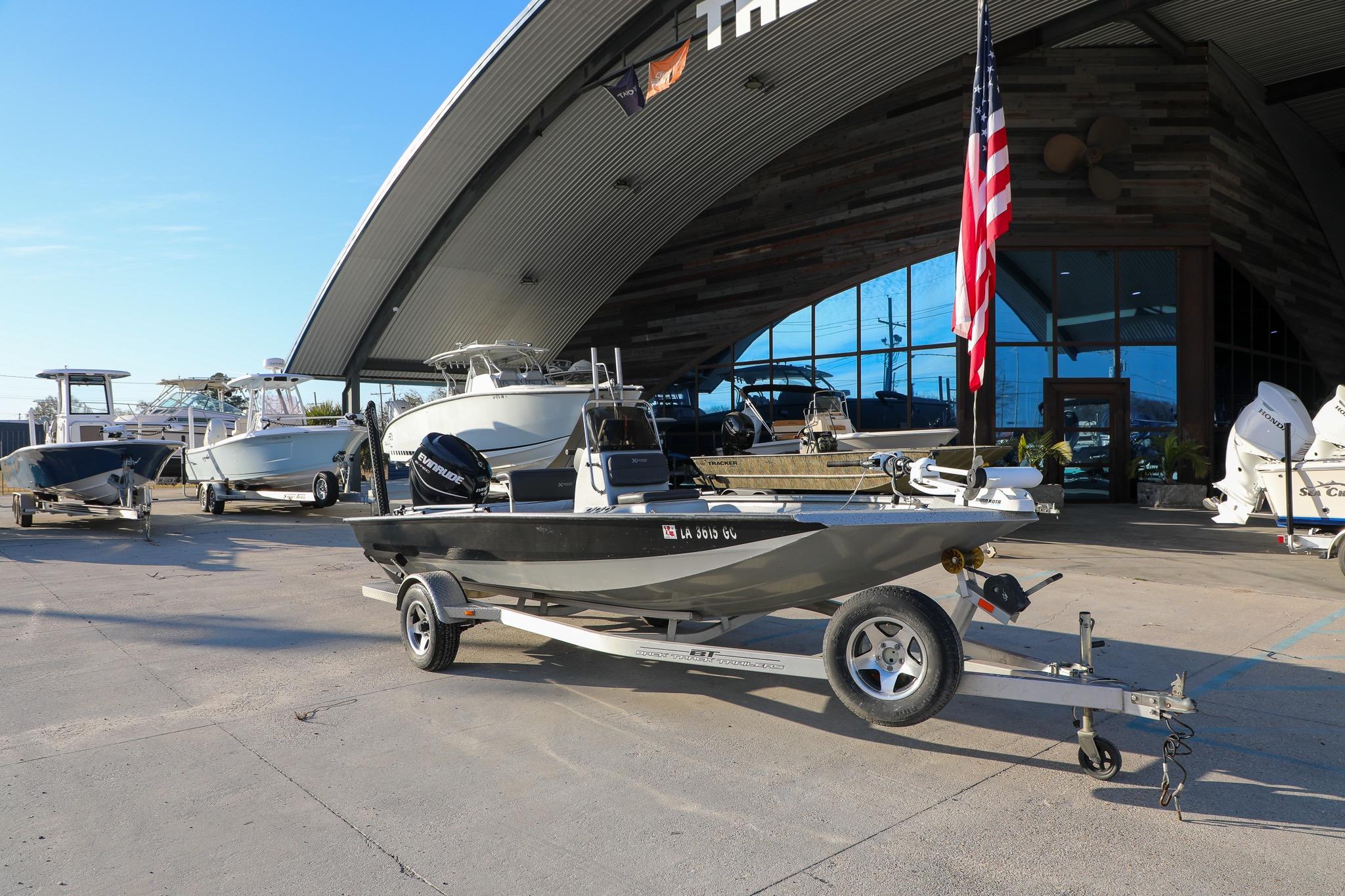 2019 Express 18 boat on trailer outside dealership with American flag.