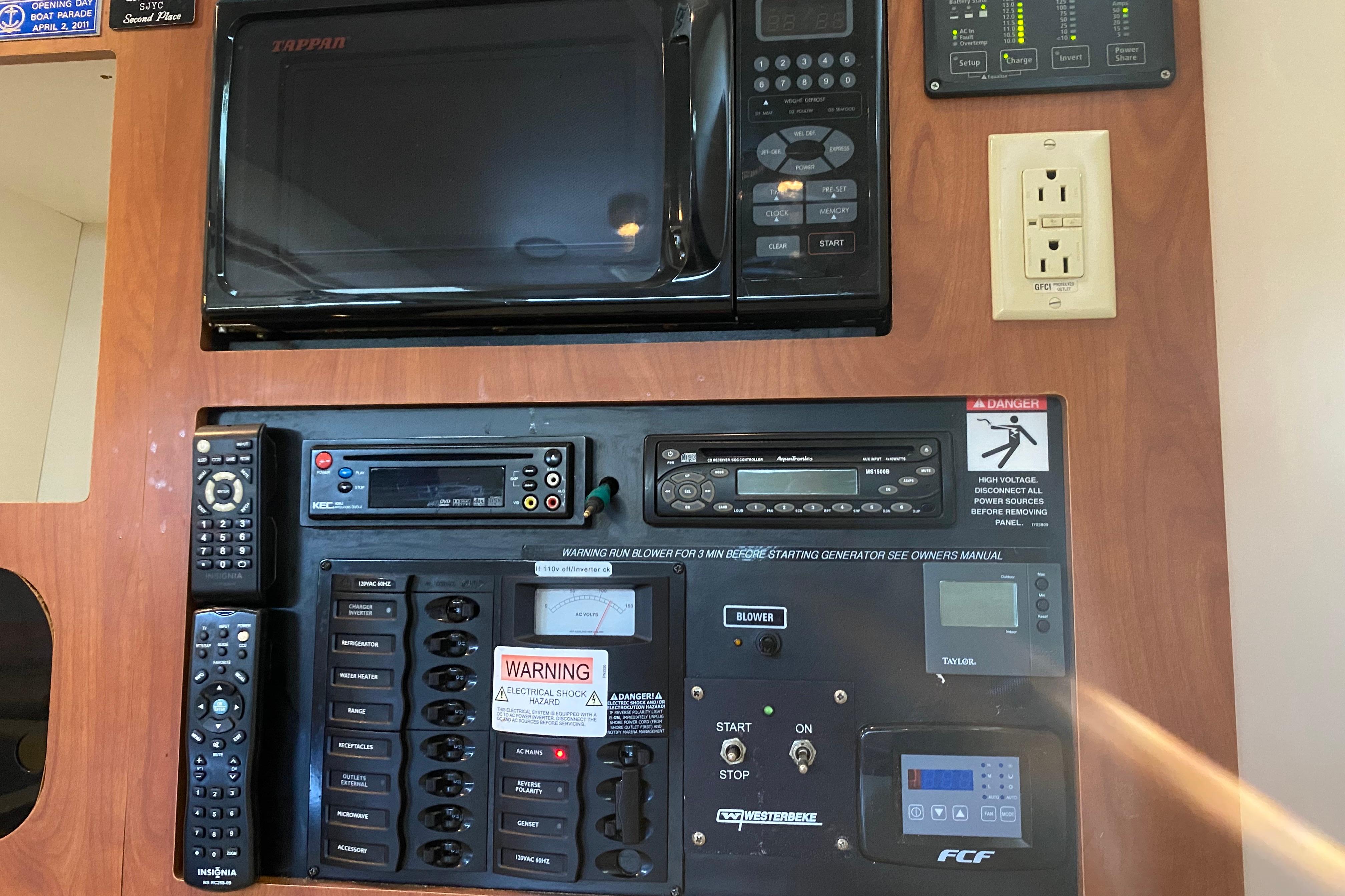 Control panel of a 2005 Bayliner 325 boat with microwave and electrical switches.