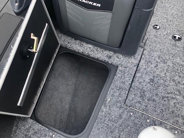 2025 Tracker Targa V18 Combo boat interior with storage compartment and carpeted flooring.