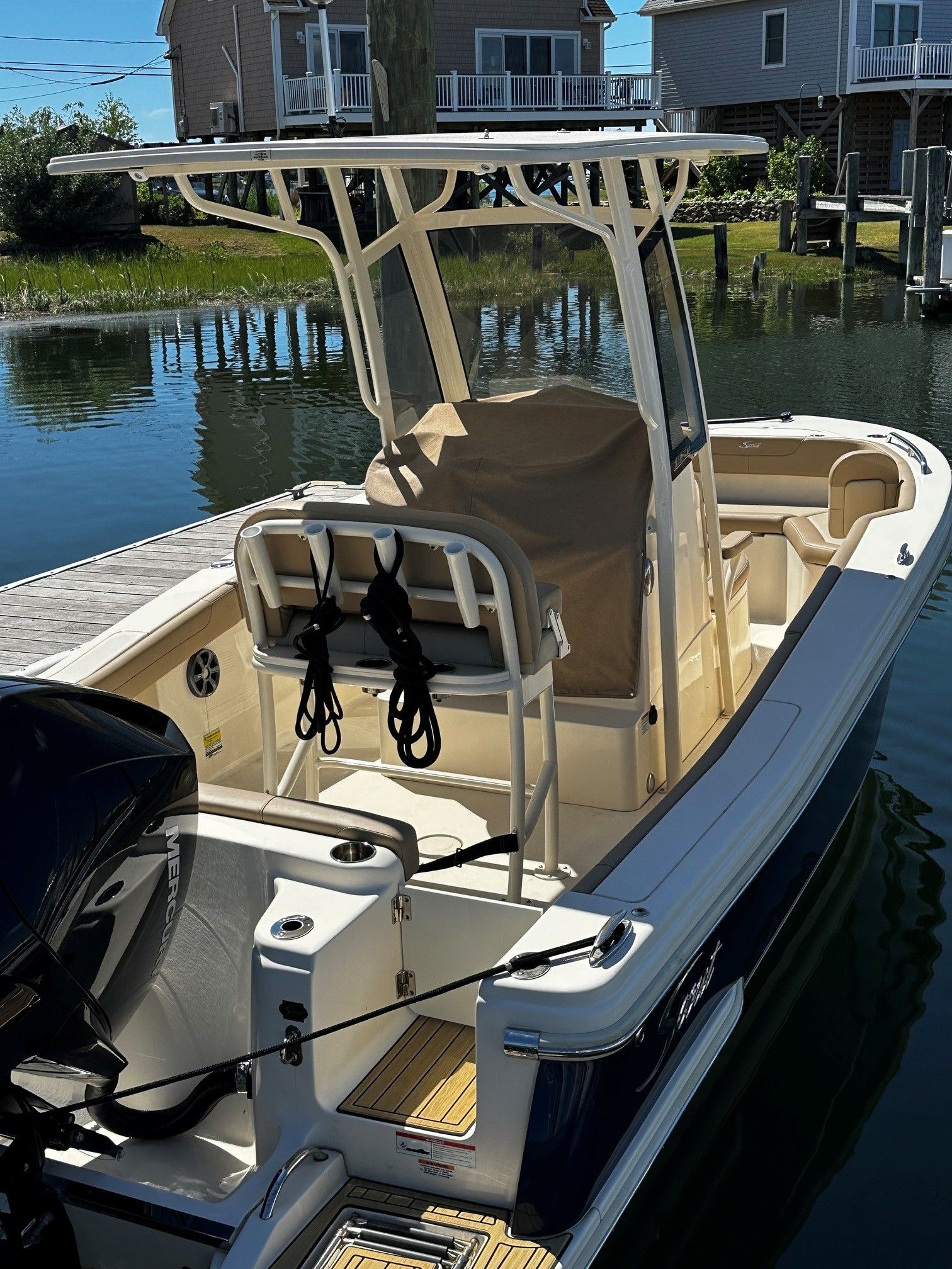 2022 Scout 210XSF boat docked by the water.