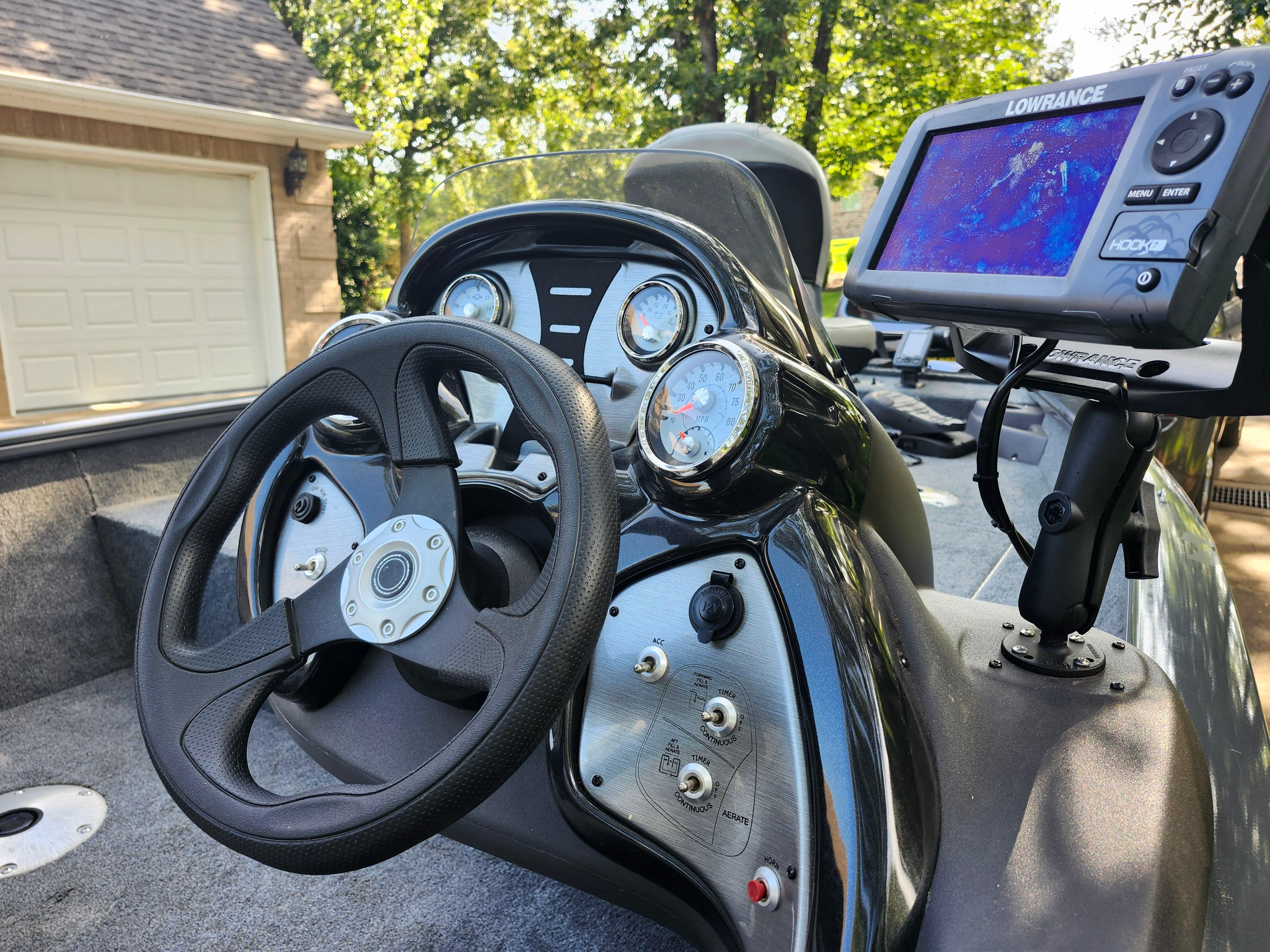 2018 Tracker Pro 175 TF boat dashboard with steering wheel and Lowrance fishfinder.