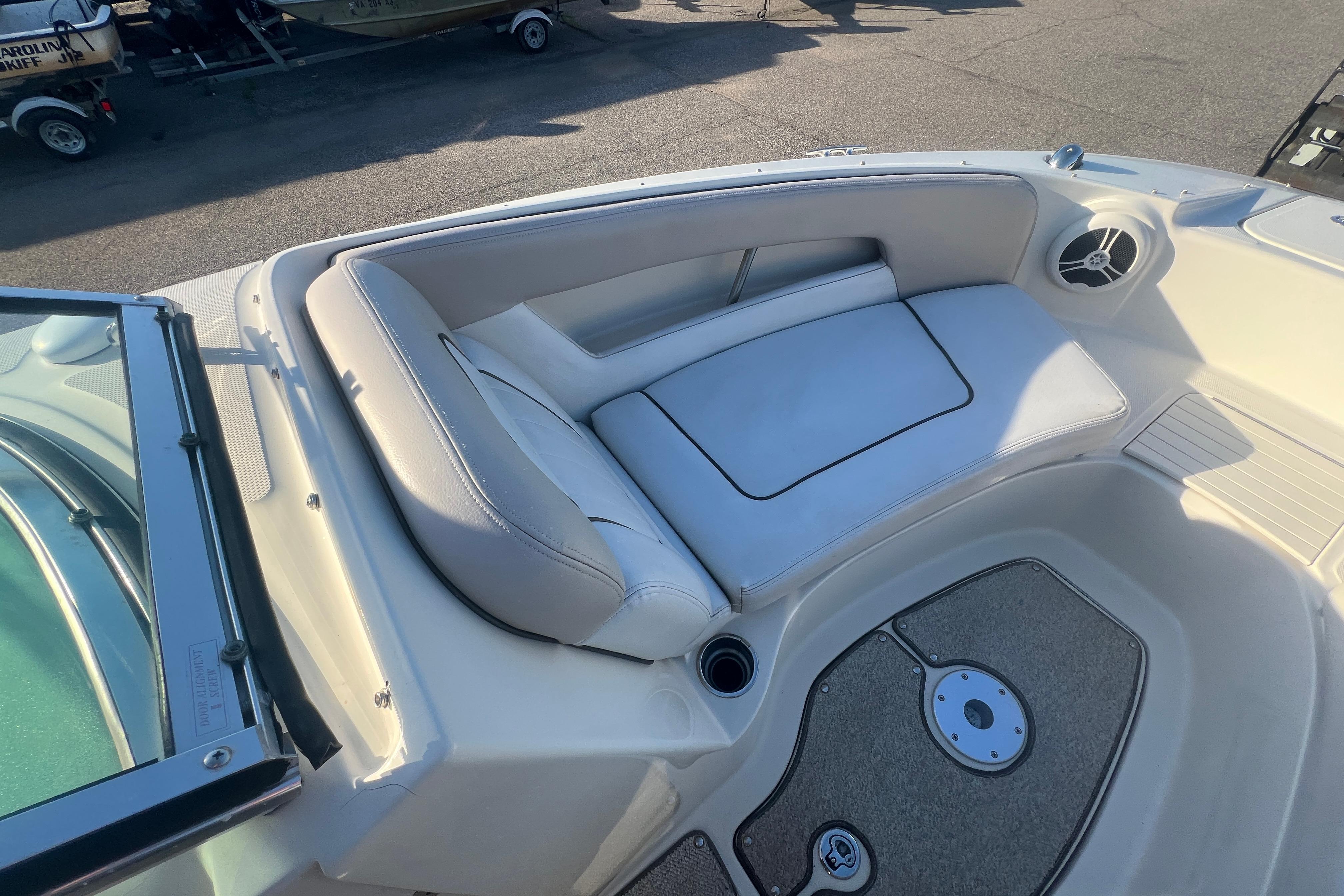 2009 Sea Ray 210 Sundeck boat interior with cushioned seating and speaker.