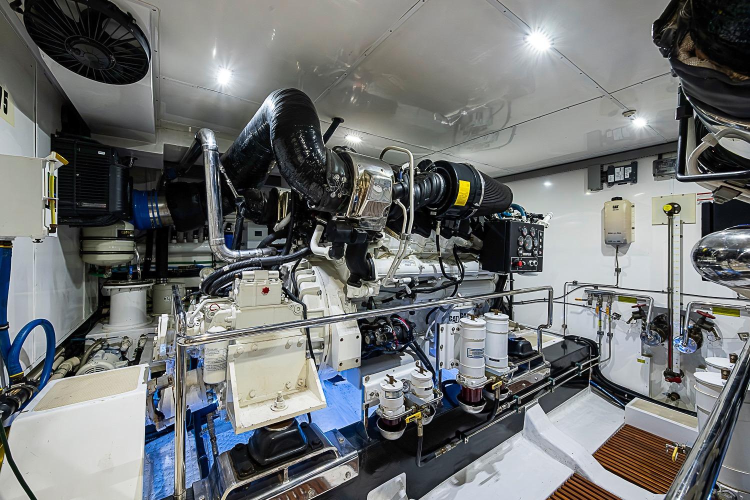 Engine room of a 2014 Marlow 80 Explorer yacht, showcasing advanced machinery and equipment.