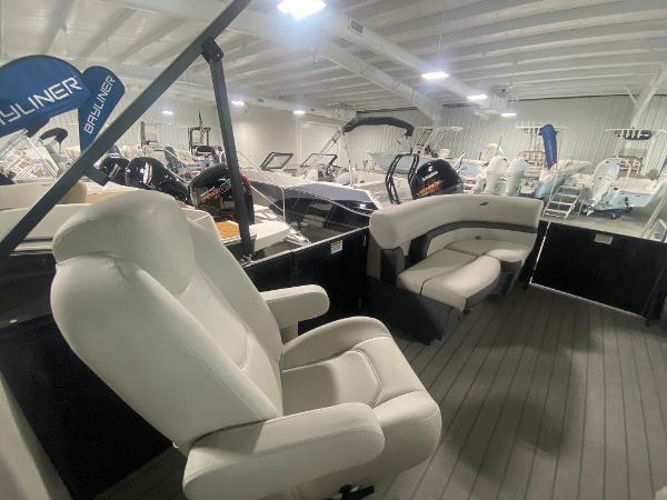 2024 Starcraft EXS 1 boat interior with white seating in a showroom.