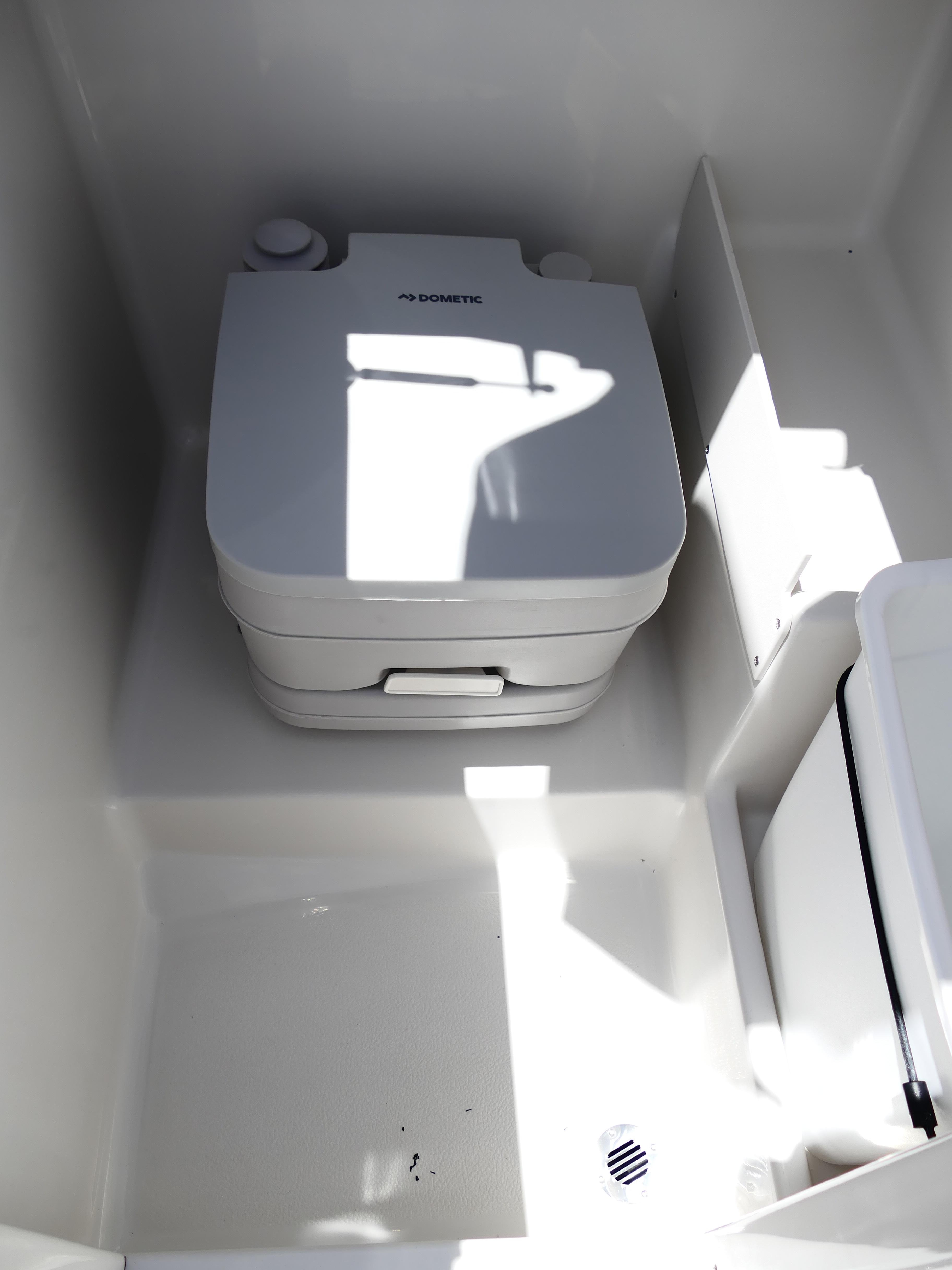 Portable toilet in 2026 Starcraft SVX 231 OB DH boat interior.