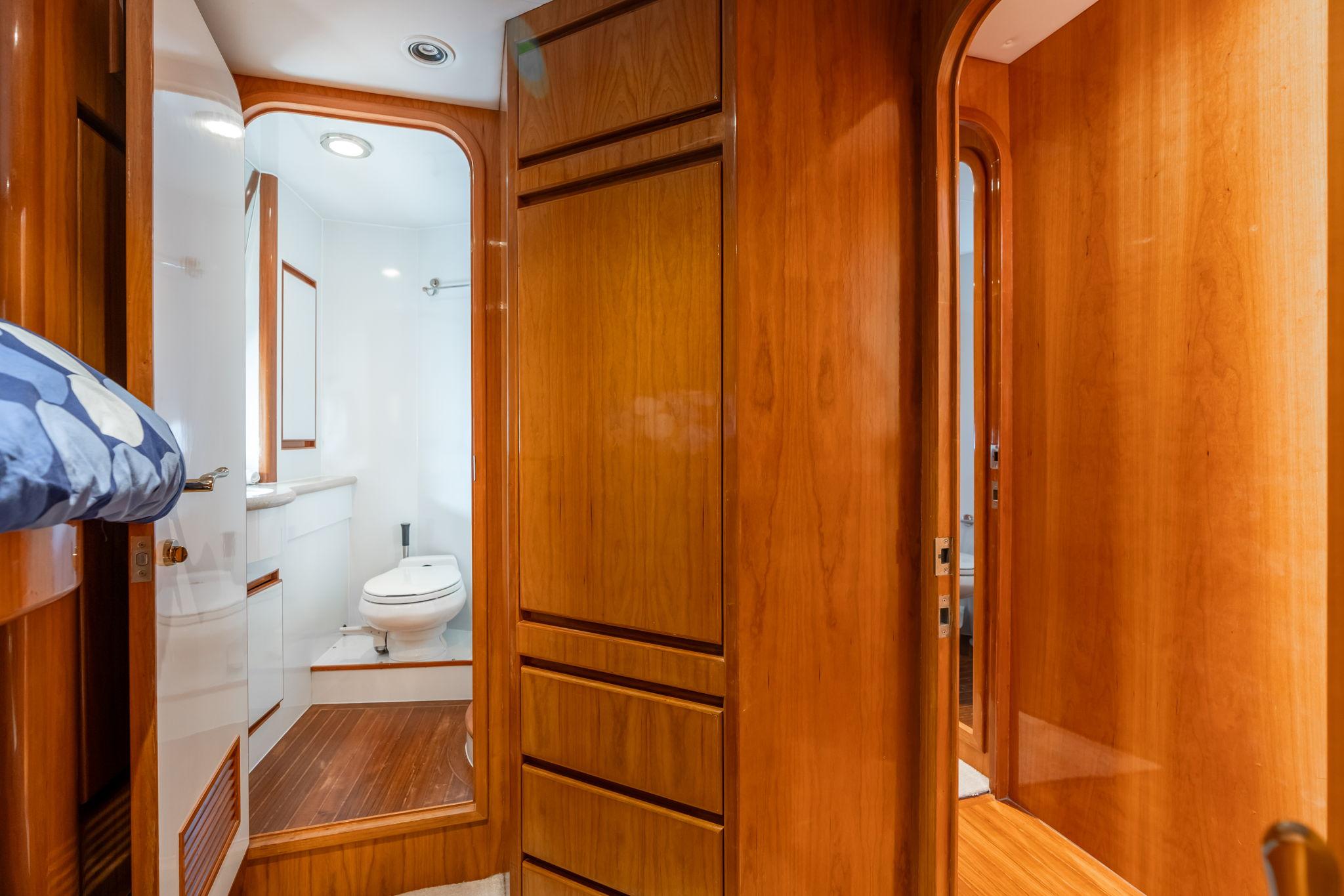Luxurious wooden interior of 1999 Vitech 68' Pilothouse yacht bathroom.
